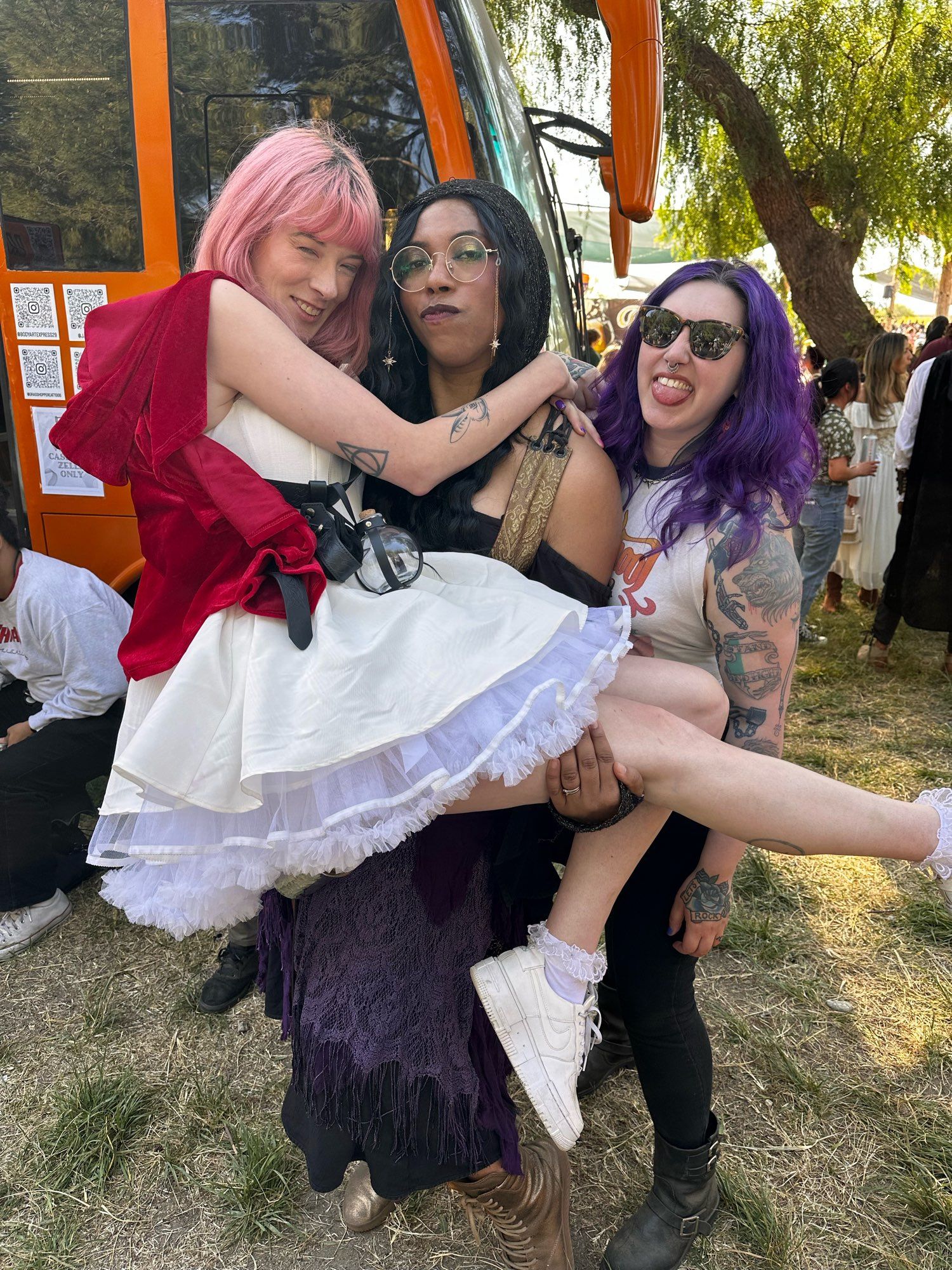 Em, Aabria holding Em, and Mallory behind Aabria are the Renn Faire. Mallory is sleeveless as always.