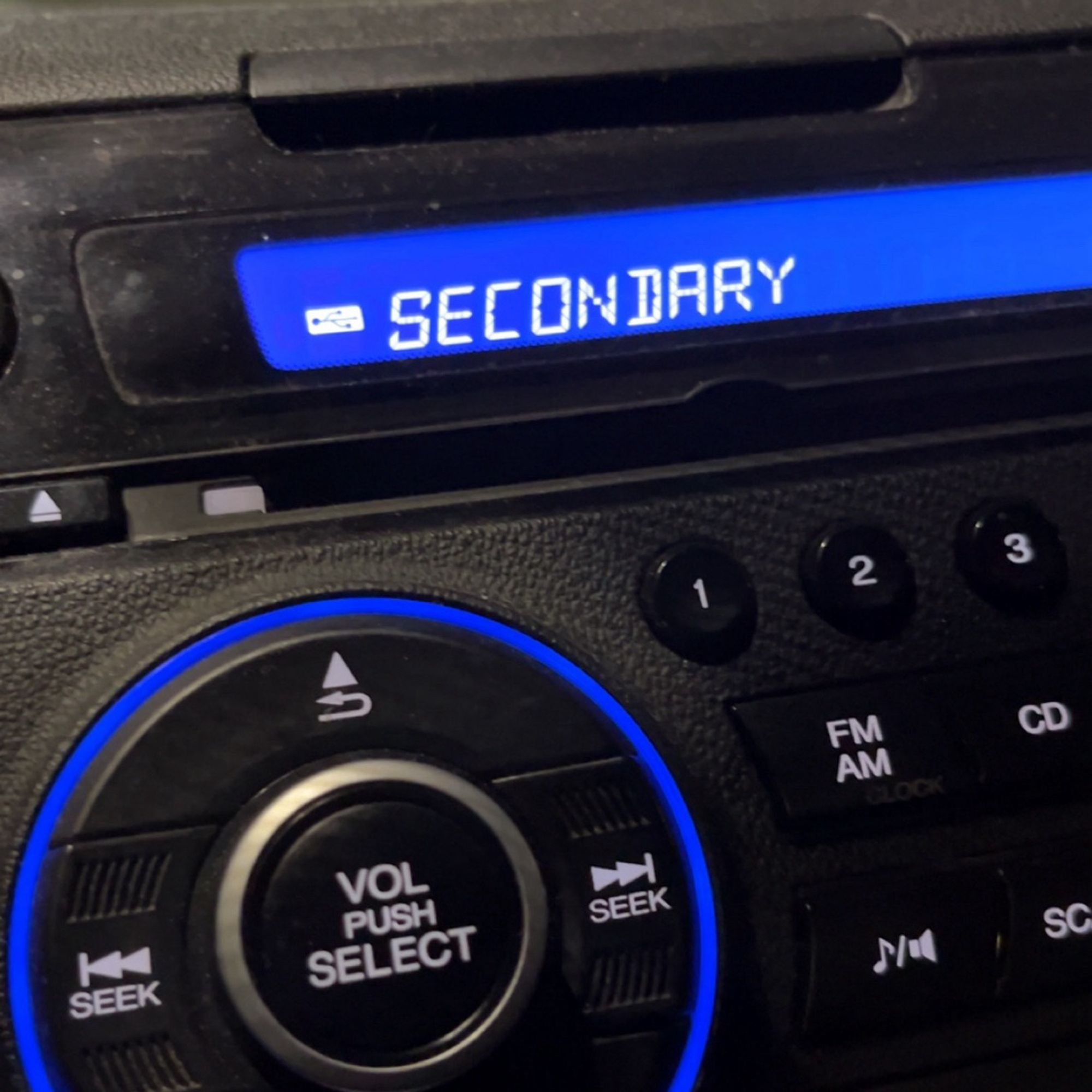 picture of a (Honda CR-Z) car radio with the word “secondary” on the display