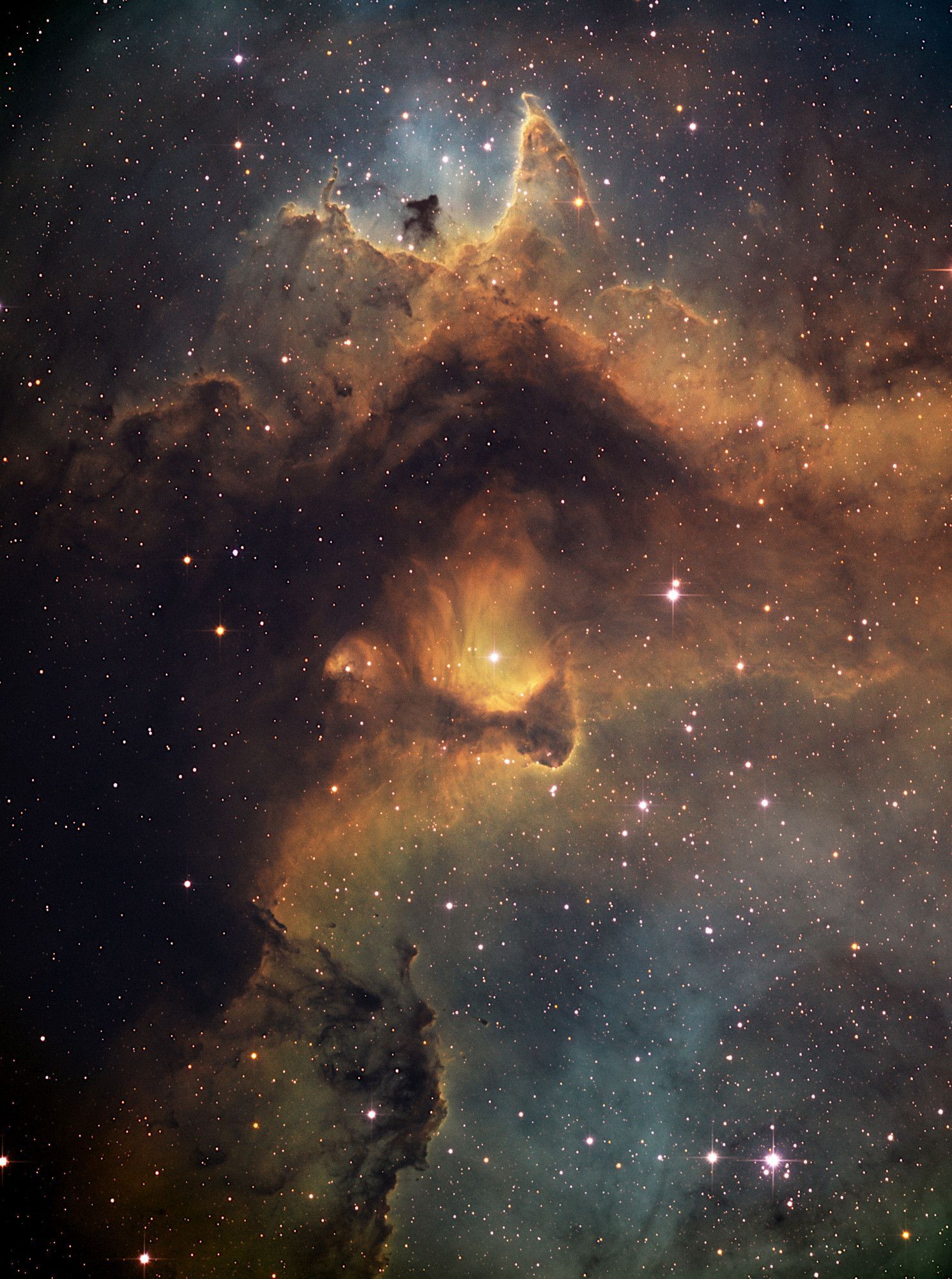 This stunning image captures a fragment of the Soul Nebula, located in the constellation Cassiopeia. The nebula's intricate structures, formed by glowing gas and dust, resemble ethereal shapes, embodying the beauty and mystery of star formation. Its vibrant hues, sculpted by stellar winds and radiation, radiate a cosmic warmth, highlighting the nebula's ongoing stellar nursery.