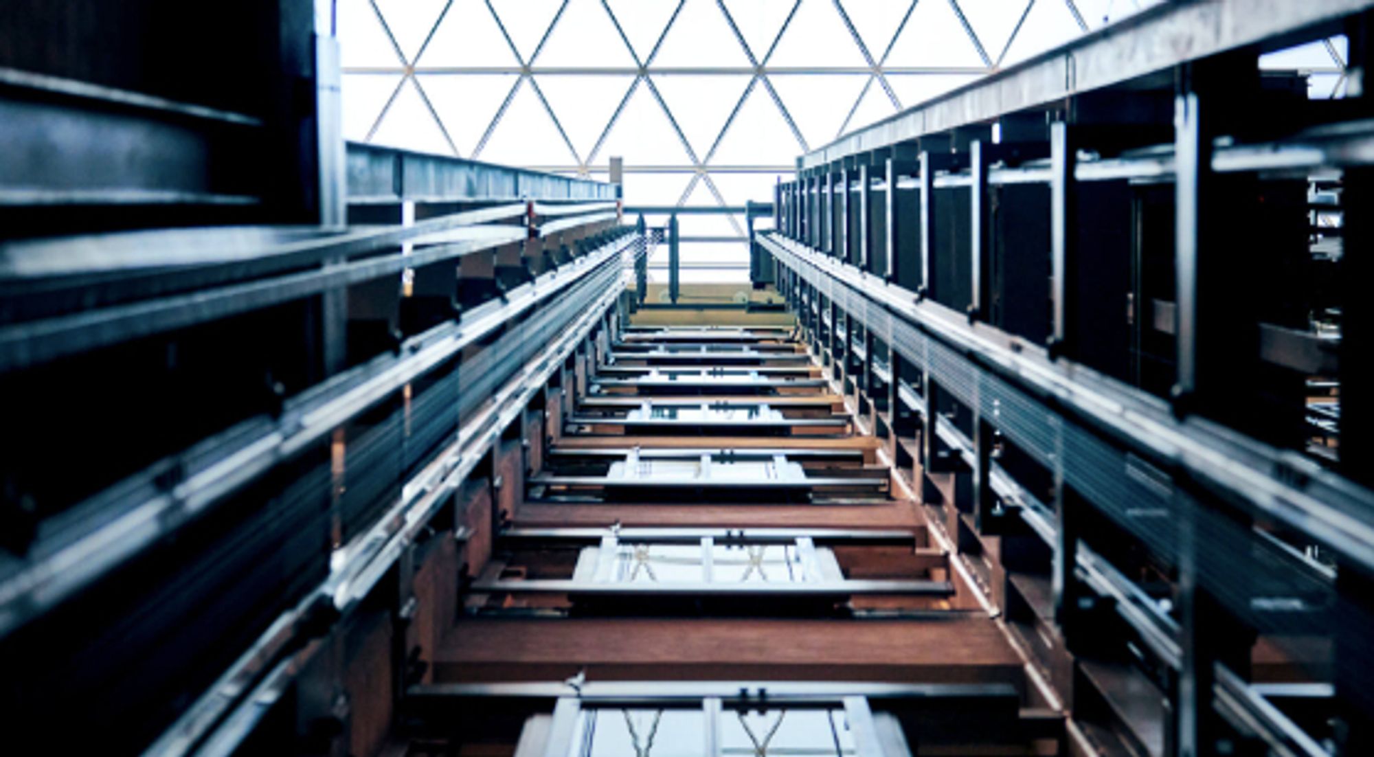 very deep elevator shaft reaching up to the glass ceiling way above.