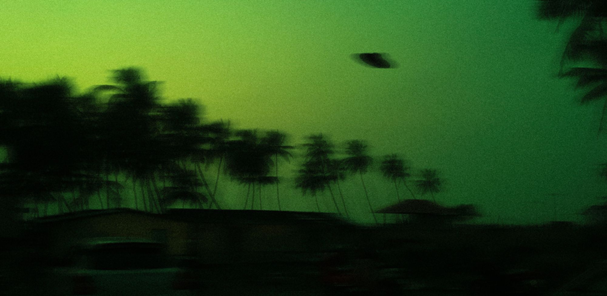 The silhouette of a UFO against a night sky