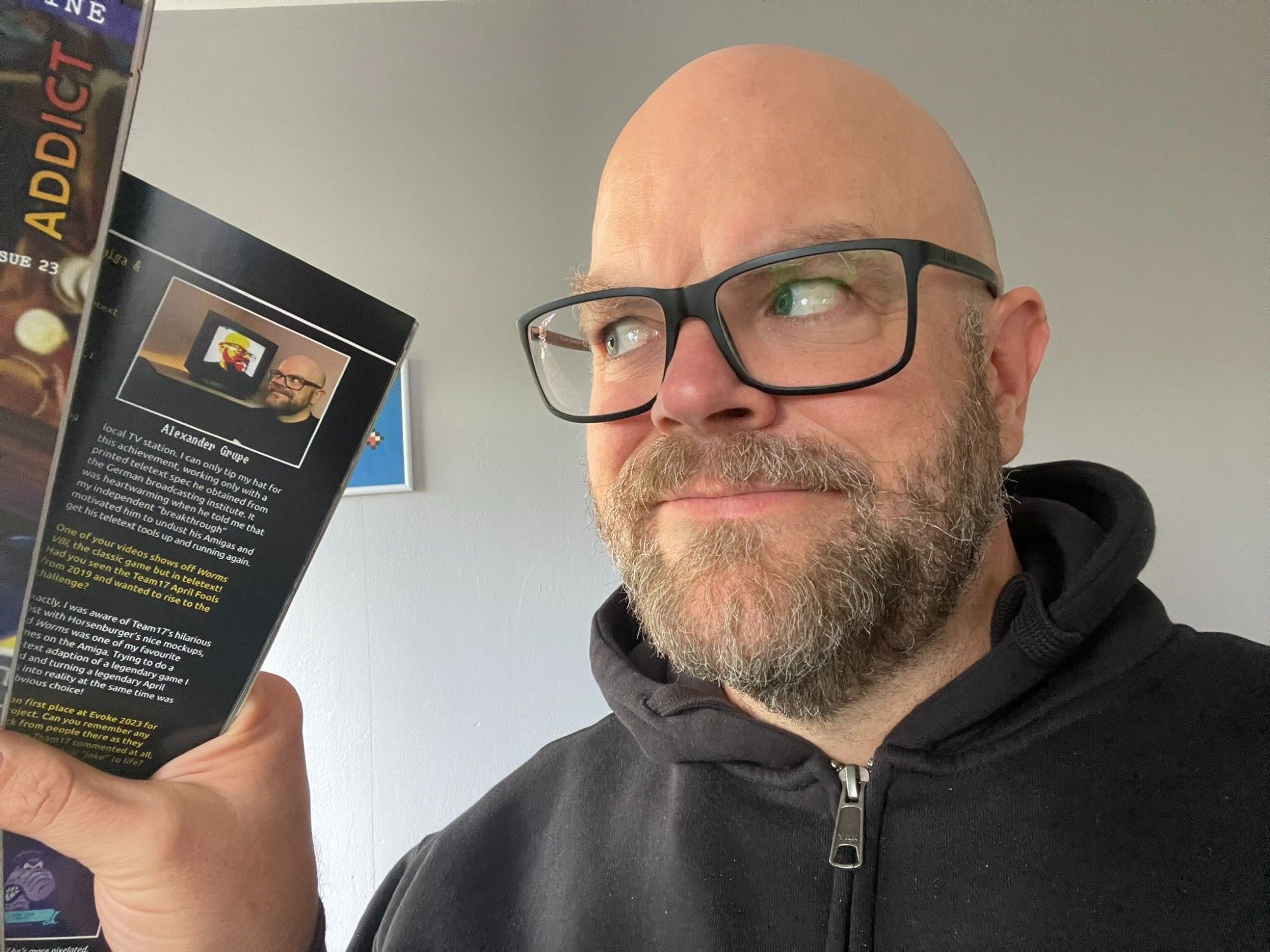 Me holding a printed issue of Pixel Addict with a picture of me in it