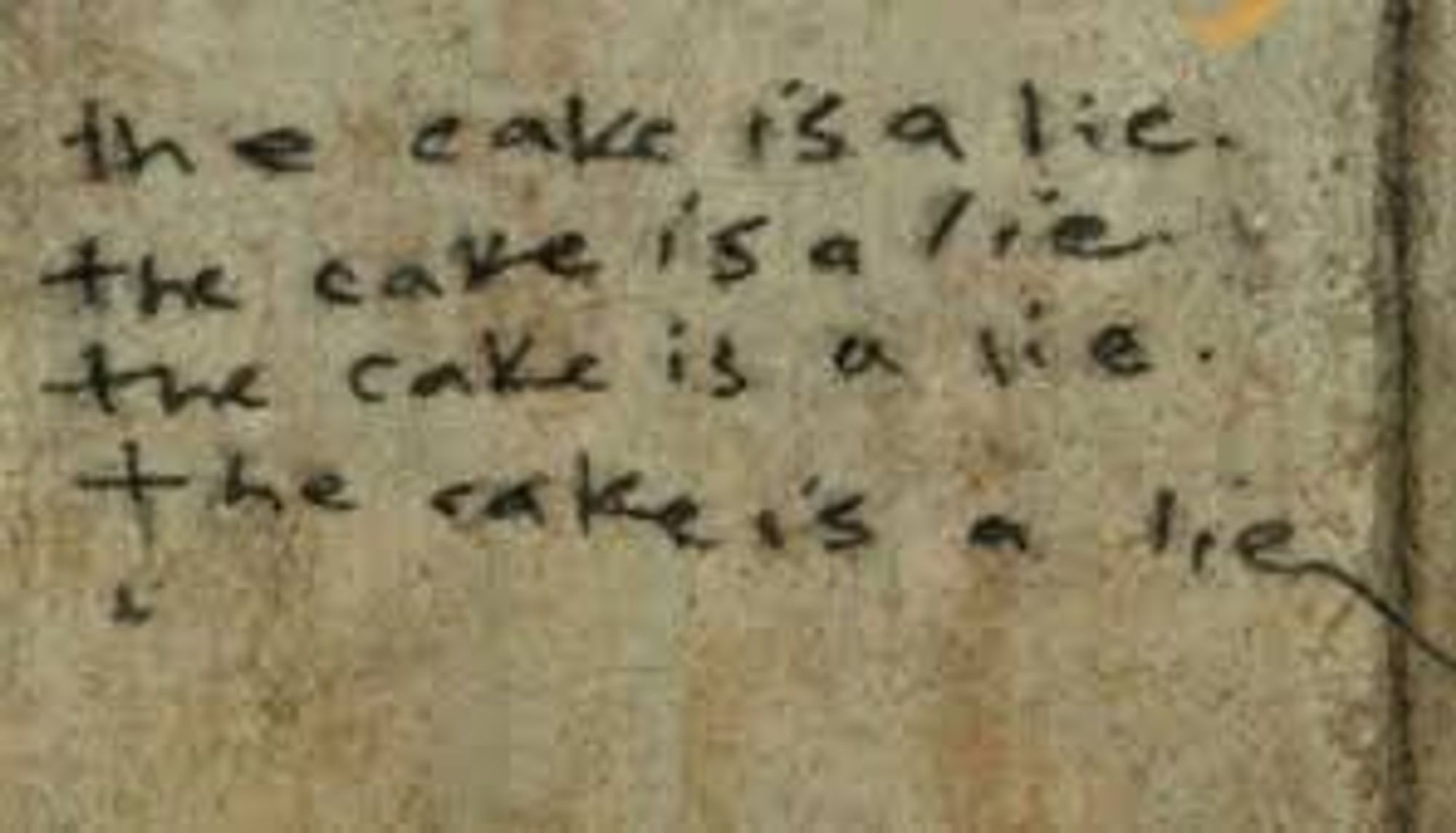 Graffiti on a wall saying "the cake is a lie" four times.