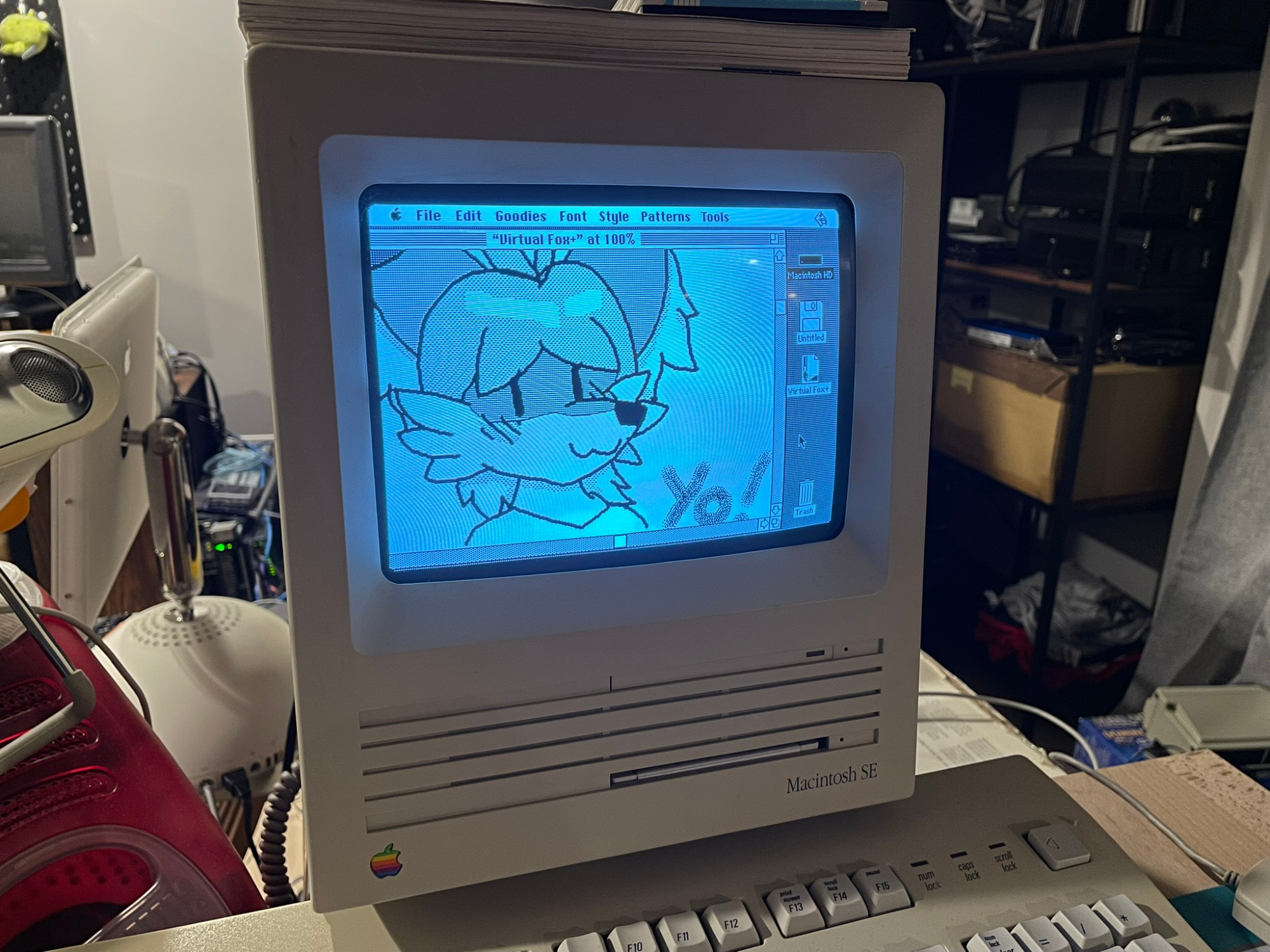 doodle of my fursona with text reading "Yo!" next to her, drawn in mac paint, on a macintosh SE