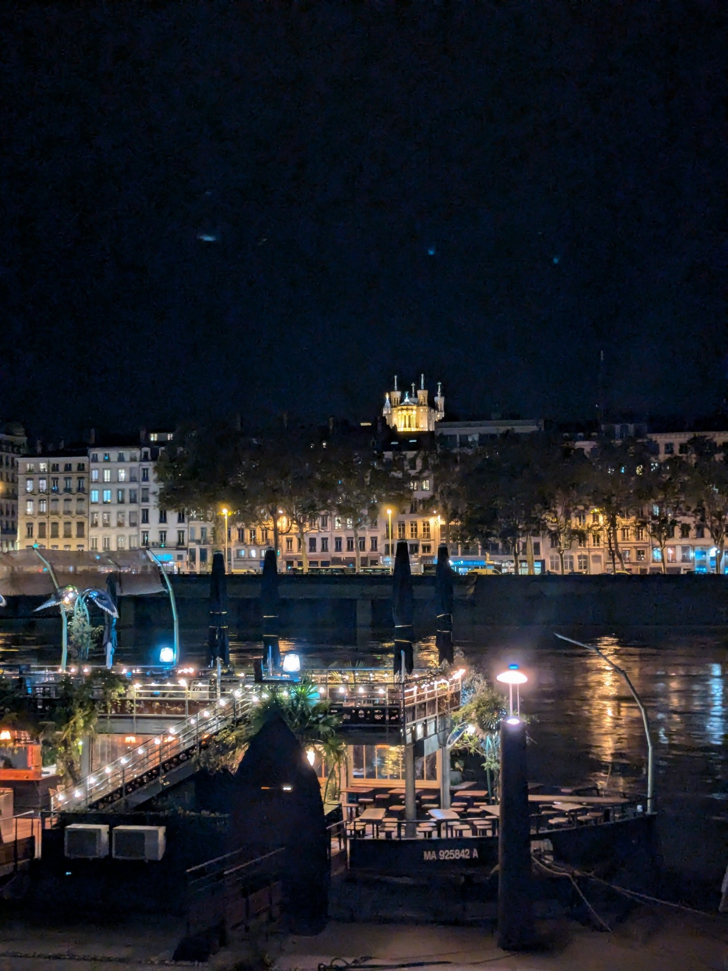 Lyon at night taken from the east bank of the River Rhône. Basilica Notre-Dame de Fourviere prominent above all other buildings.