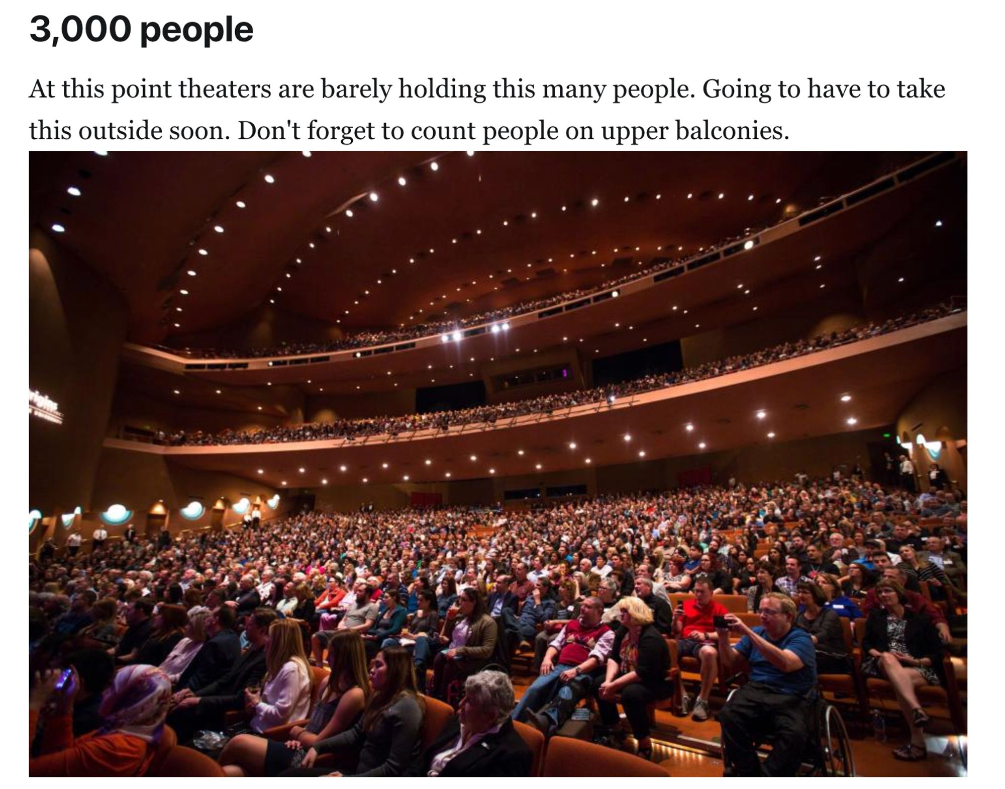 A crowded theater with attendees filling seats and upper balconies, captioned "3,000 people.