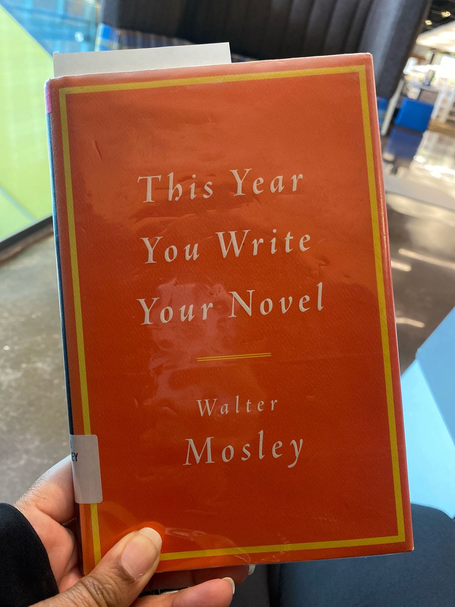 Me holding Walker Mosley’s book in a public library. “This Year You Write Your Novel” (c) 2007