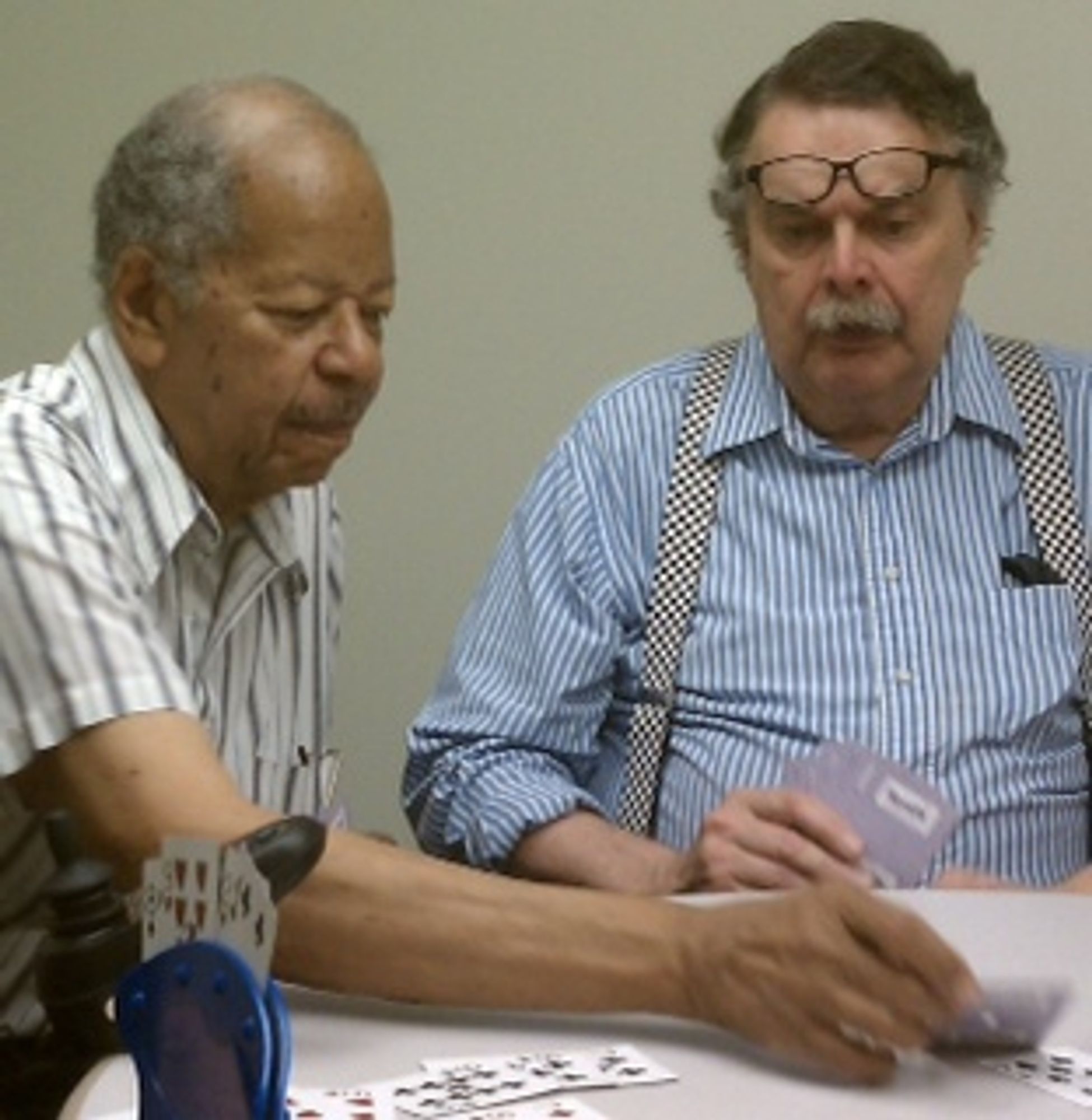 This photo shows two individuals playing cards