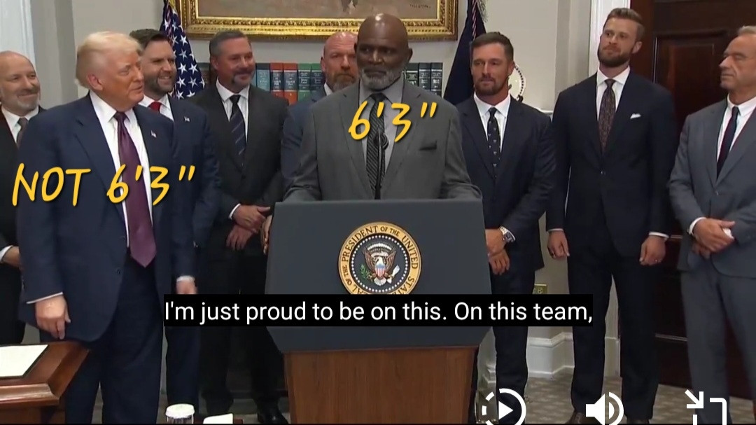 Screen shot from video showing 6'3" Lawrence Taylor standing 3-4" taller than not 6'3" Trump 