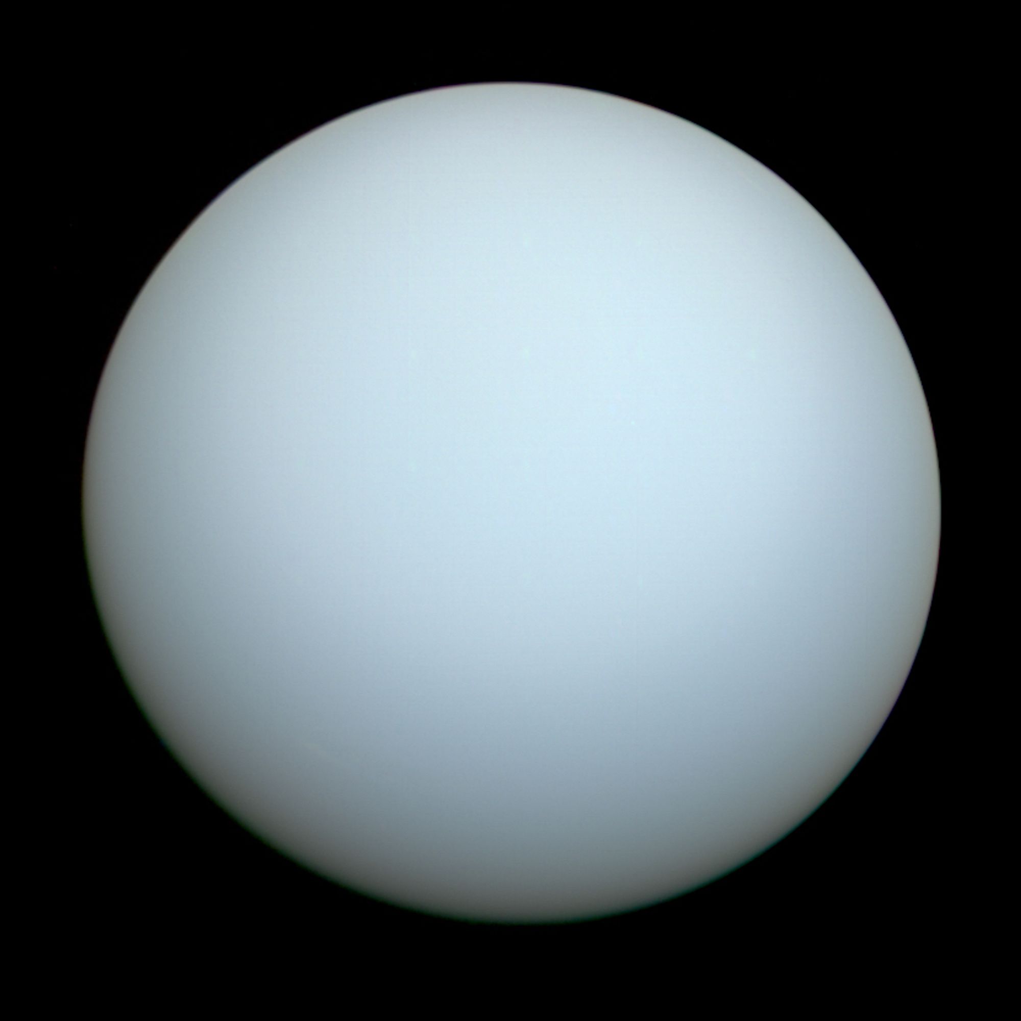 Uranus as imaged by Voyager II. The planet is a nearly featureless, pale blue disk