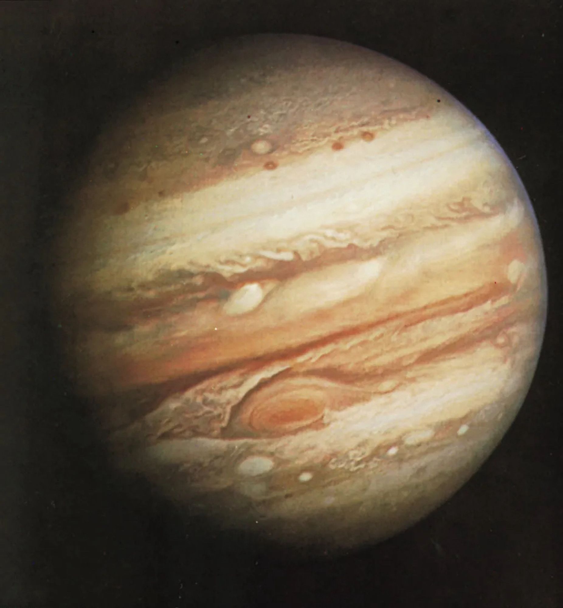 Jupiter as imaged by Voyager I. Visually the planet is composed of alternating bands of red, orange, white, and brown bands. The Great Red Spot is very prominent in the southern hemisphere