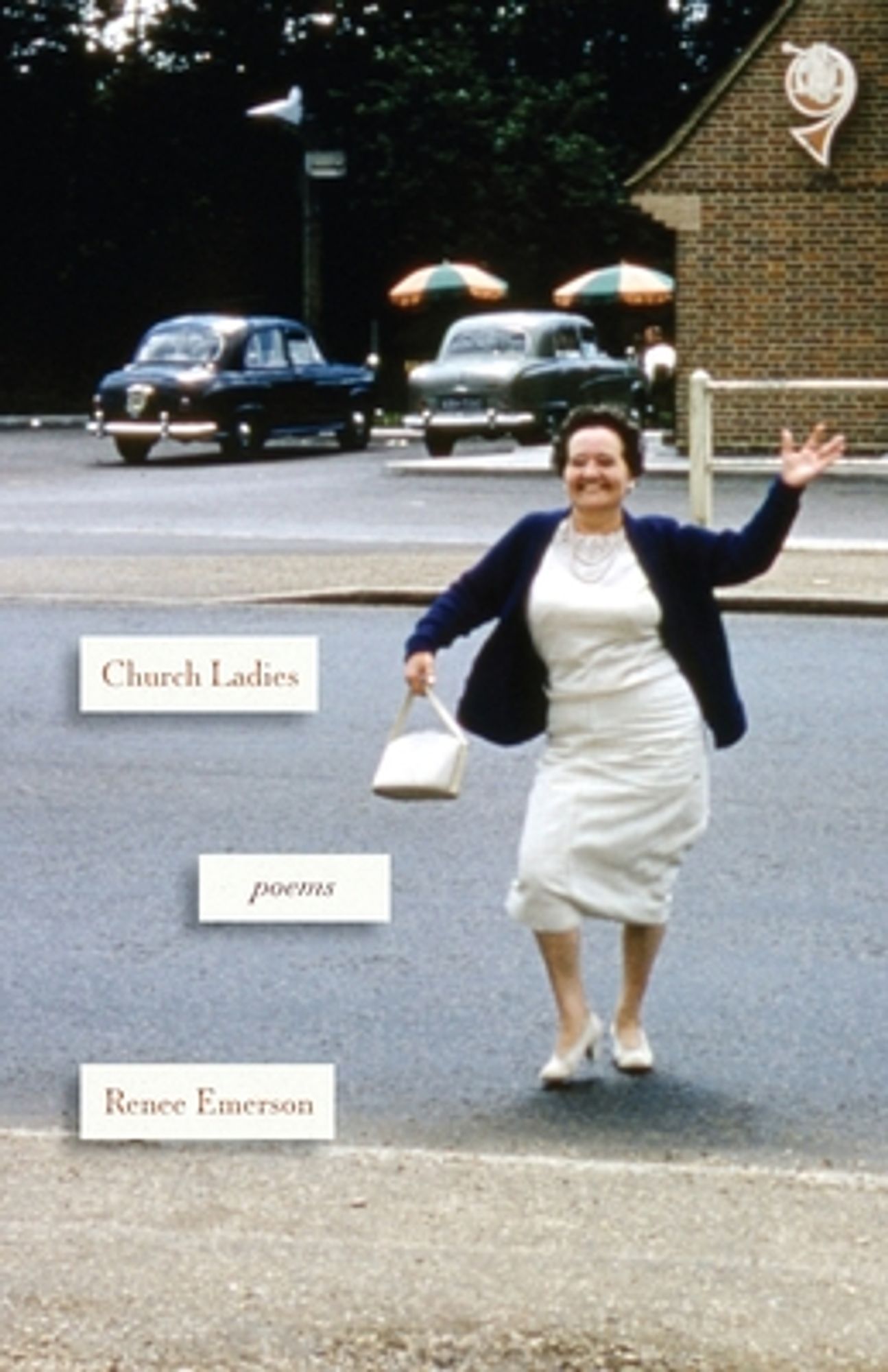 A woman in a white dress holding a white purse waves from a parking lot.