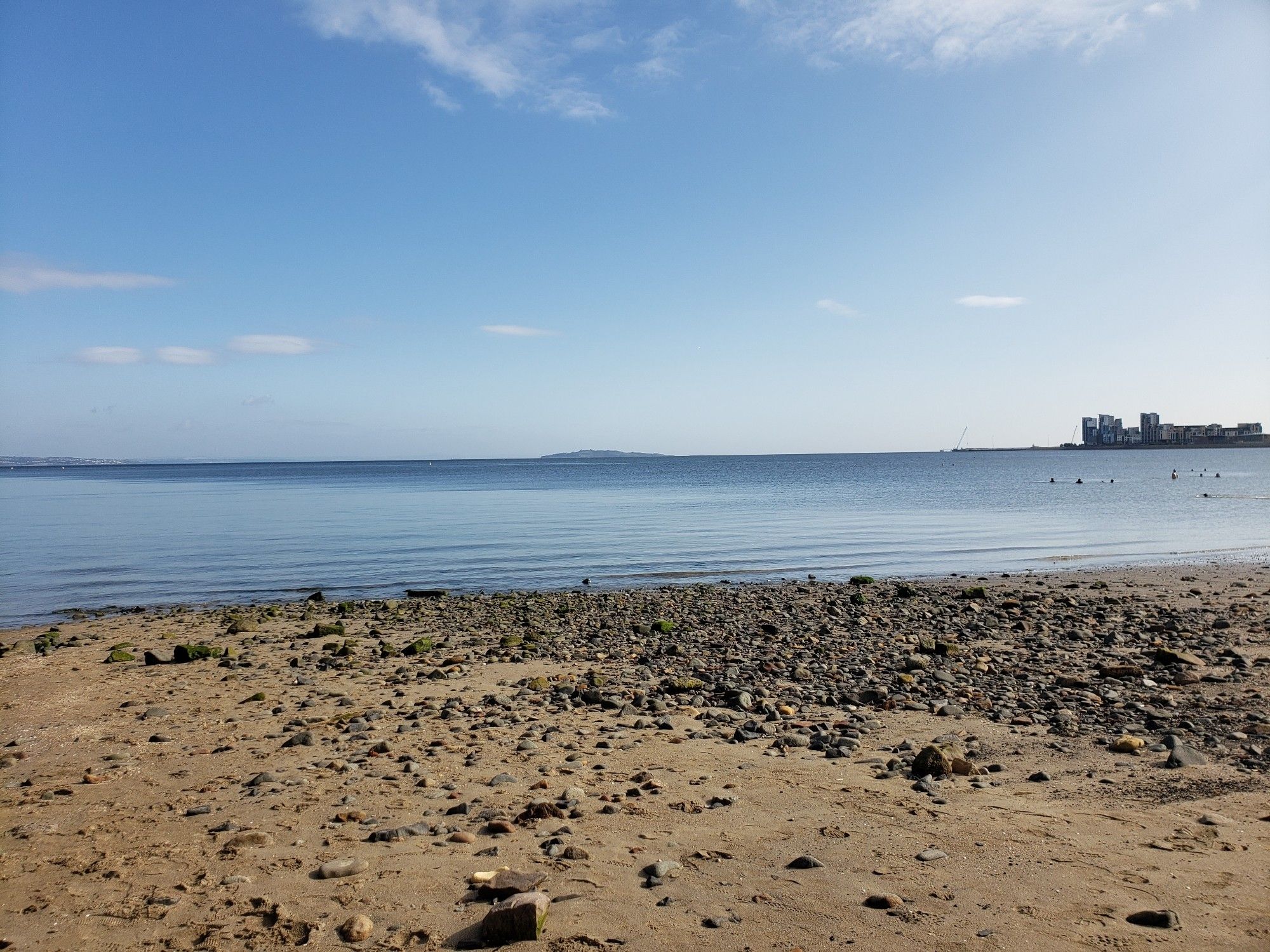 Flat calm blue sea and a sandy beach