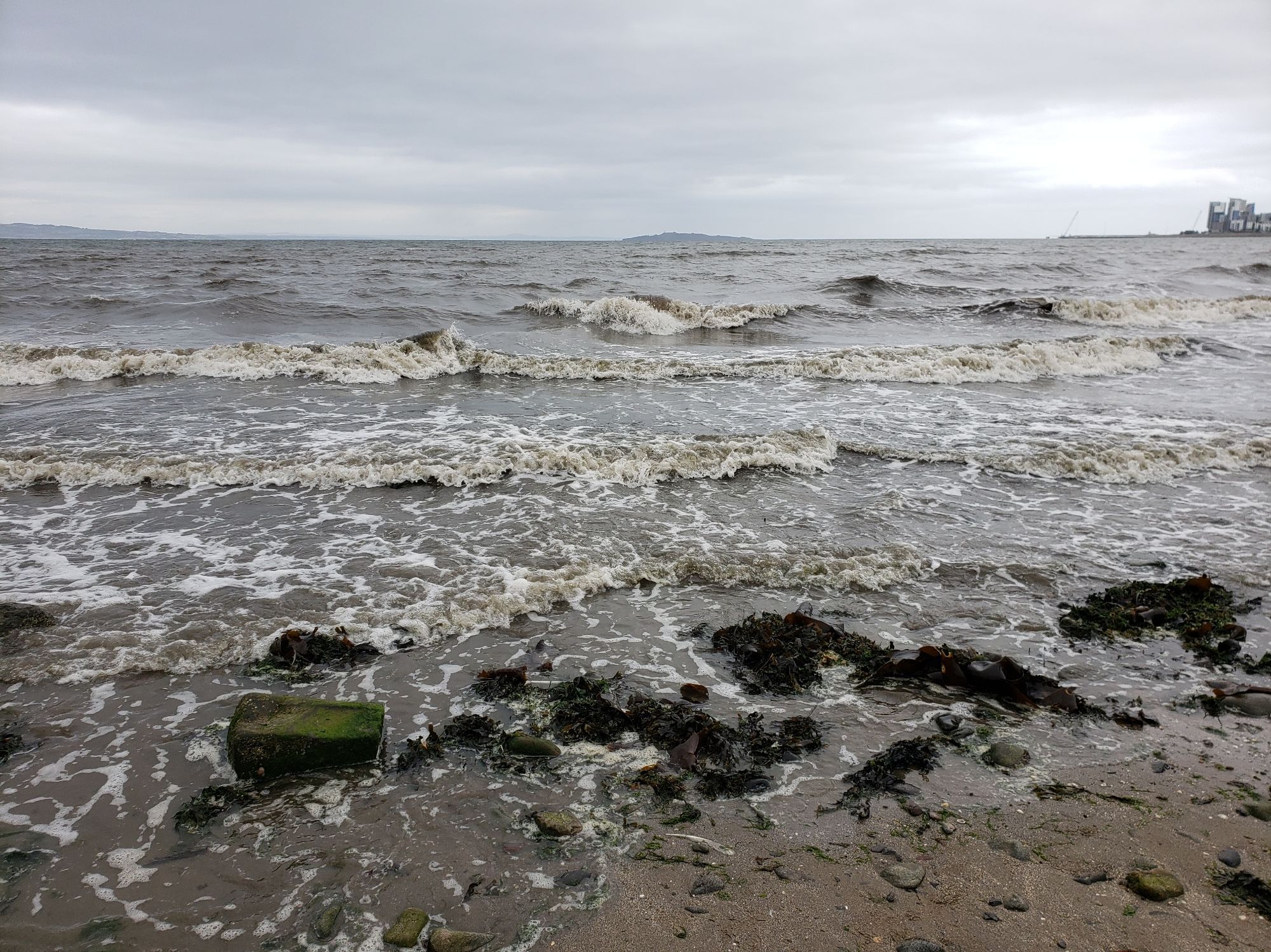 Rough waves crashing onto a sandy beach