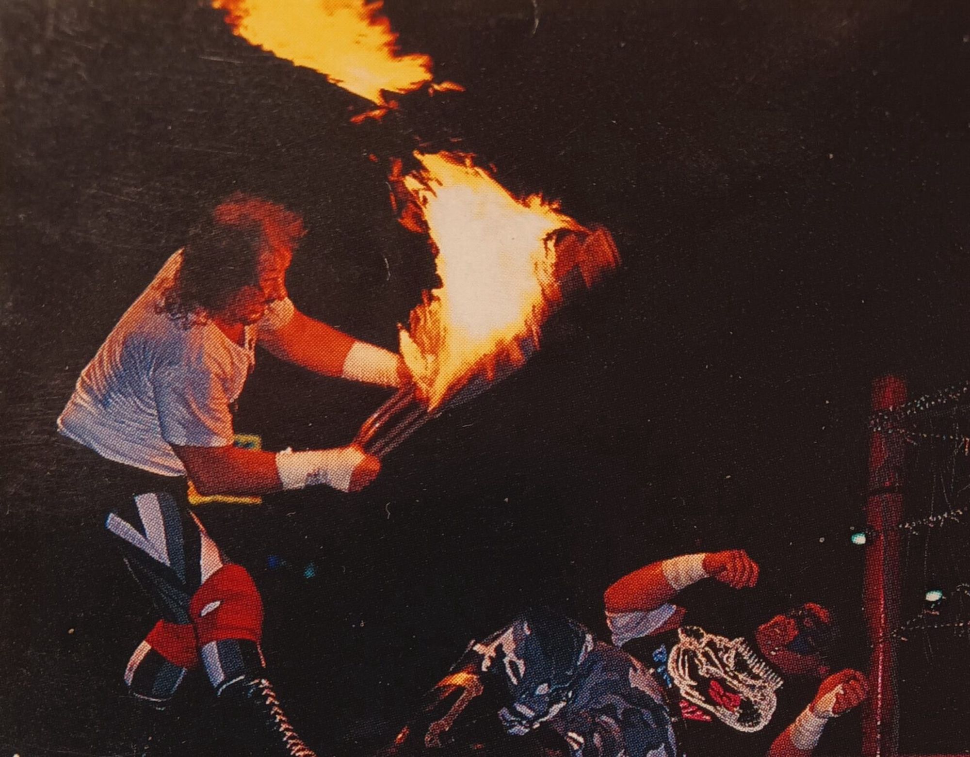 Terry Funk hits Mr. Pogo with a flaming chair.