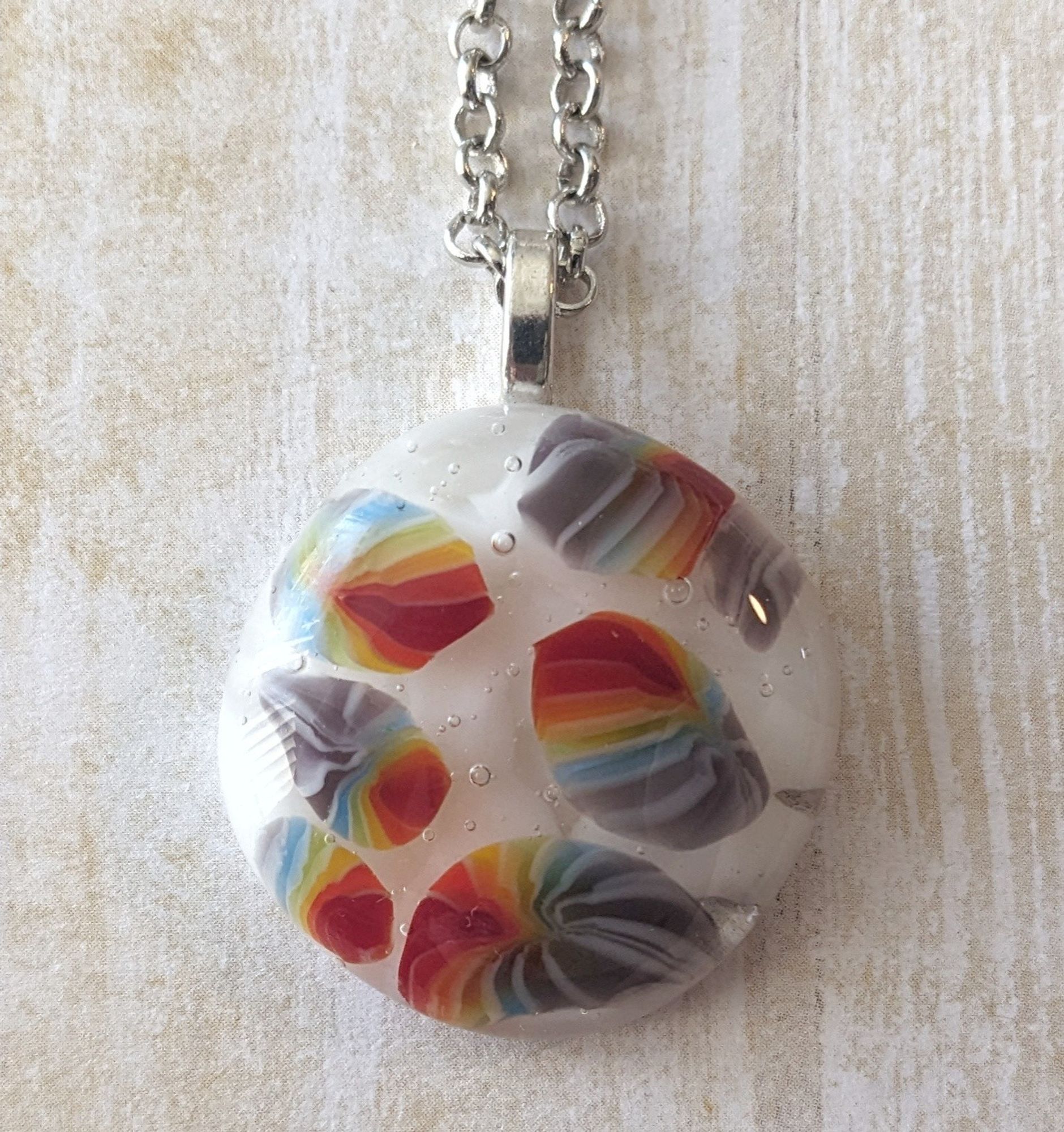 pendant with white background and rainbow foreground