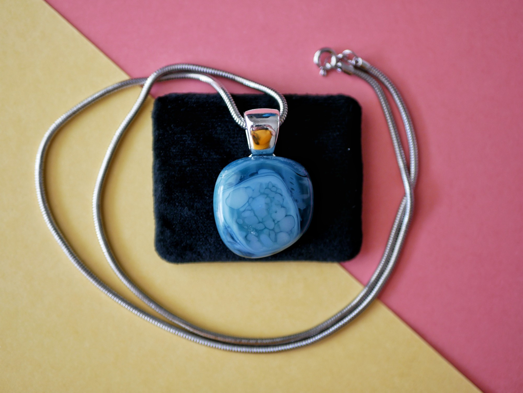 blue pendant with lighter color speckles 