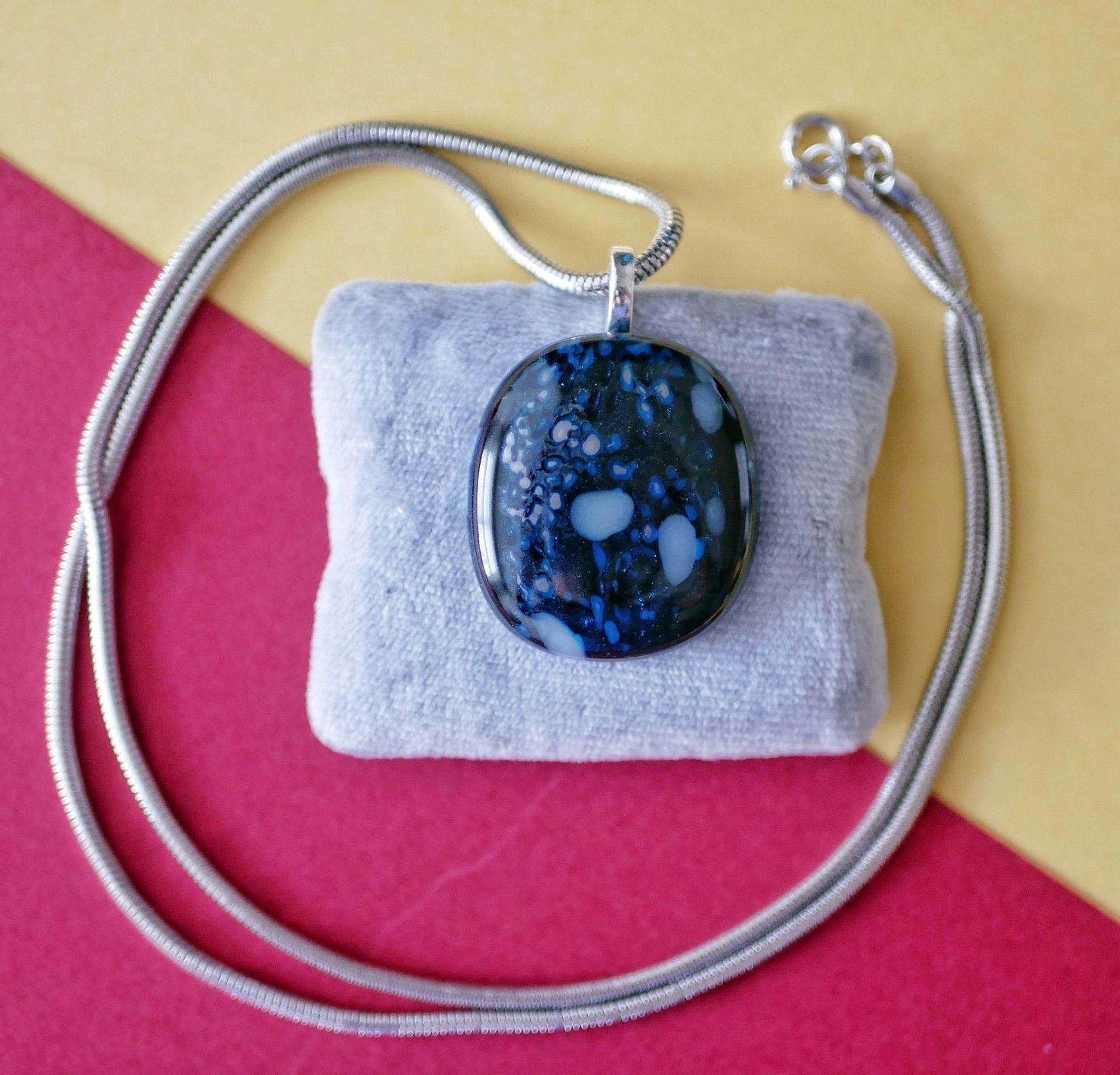 blue sparkly pendant with white spots