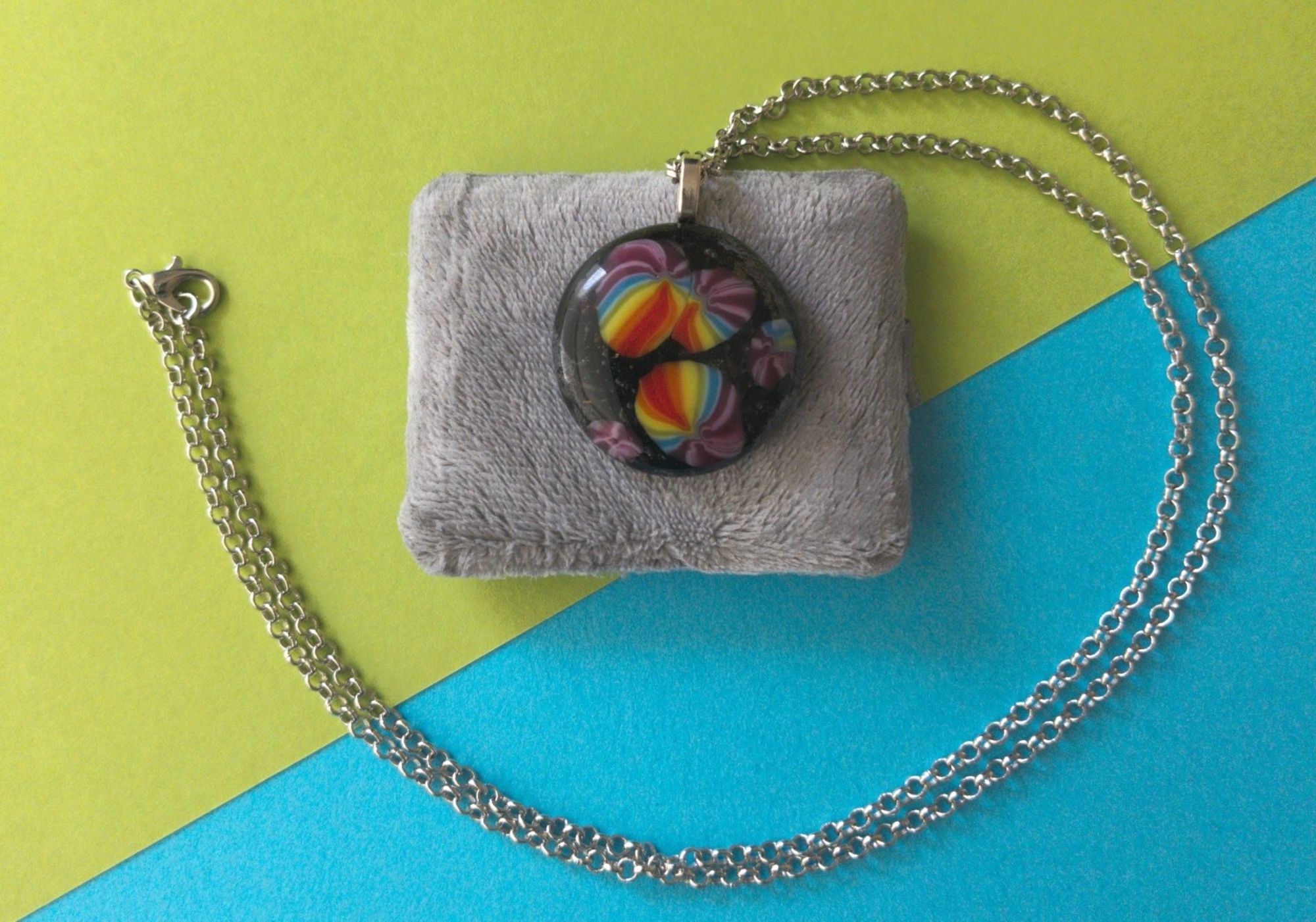 black pendant with rainbows in the foreground