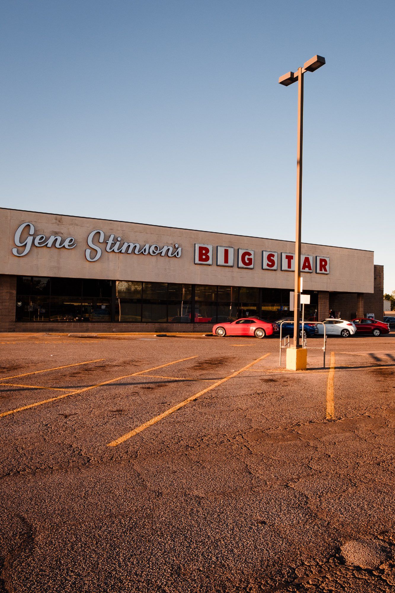 Golden hour illuminates the entrance of Big Star supermarket.