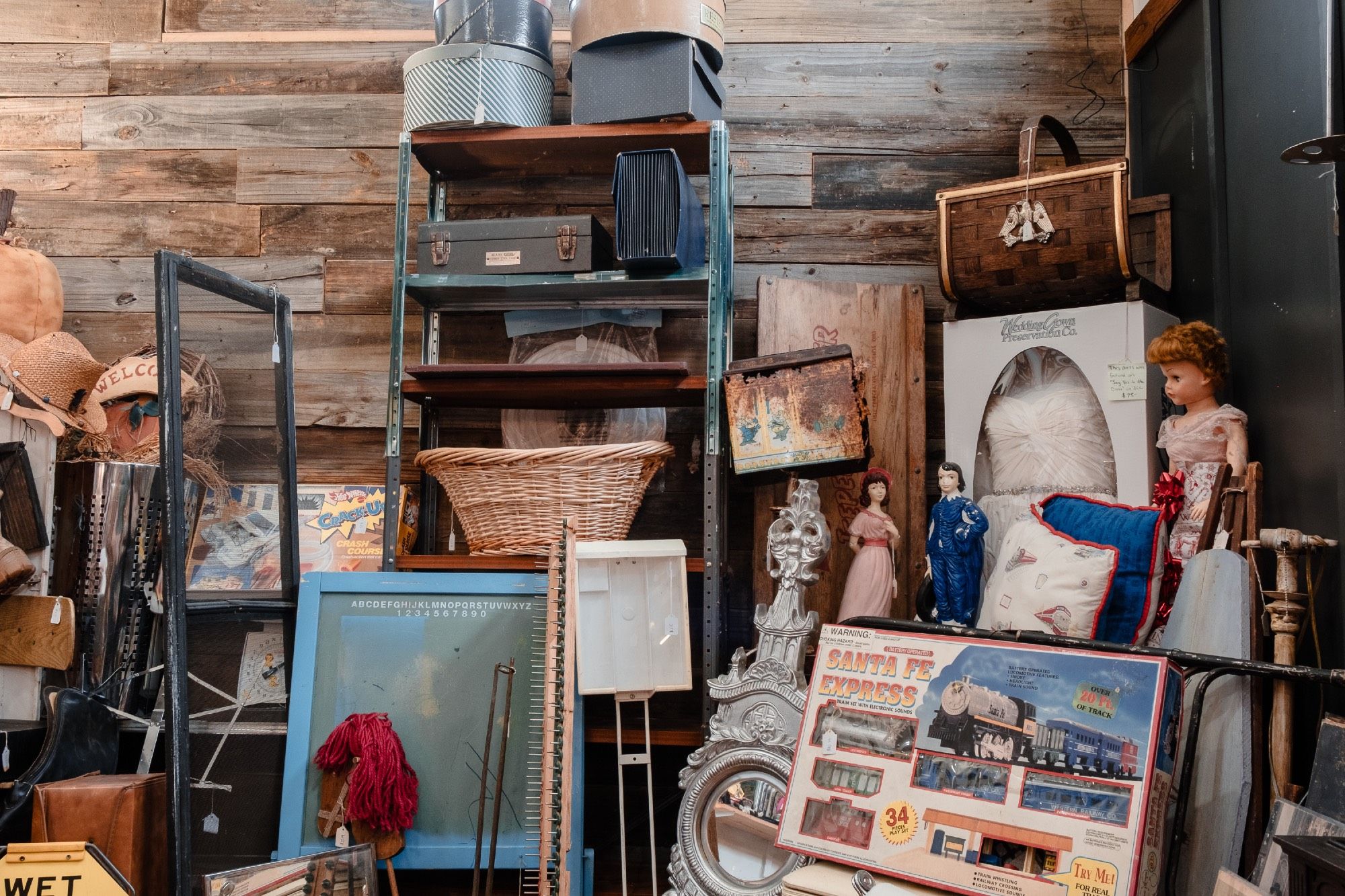 Assorted wares stacked in an antique/junk shop.