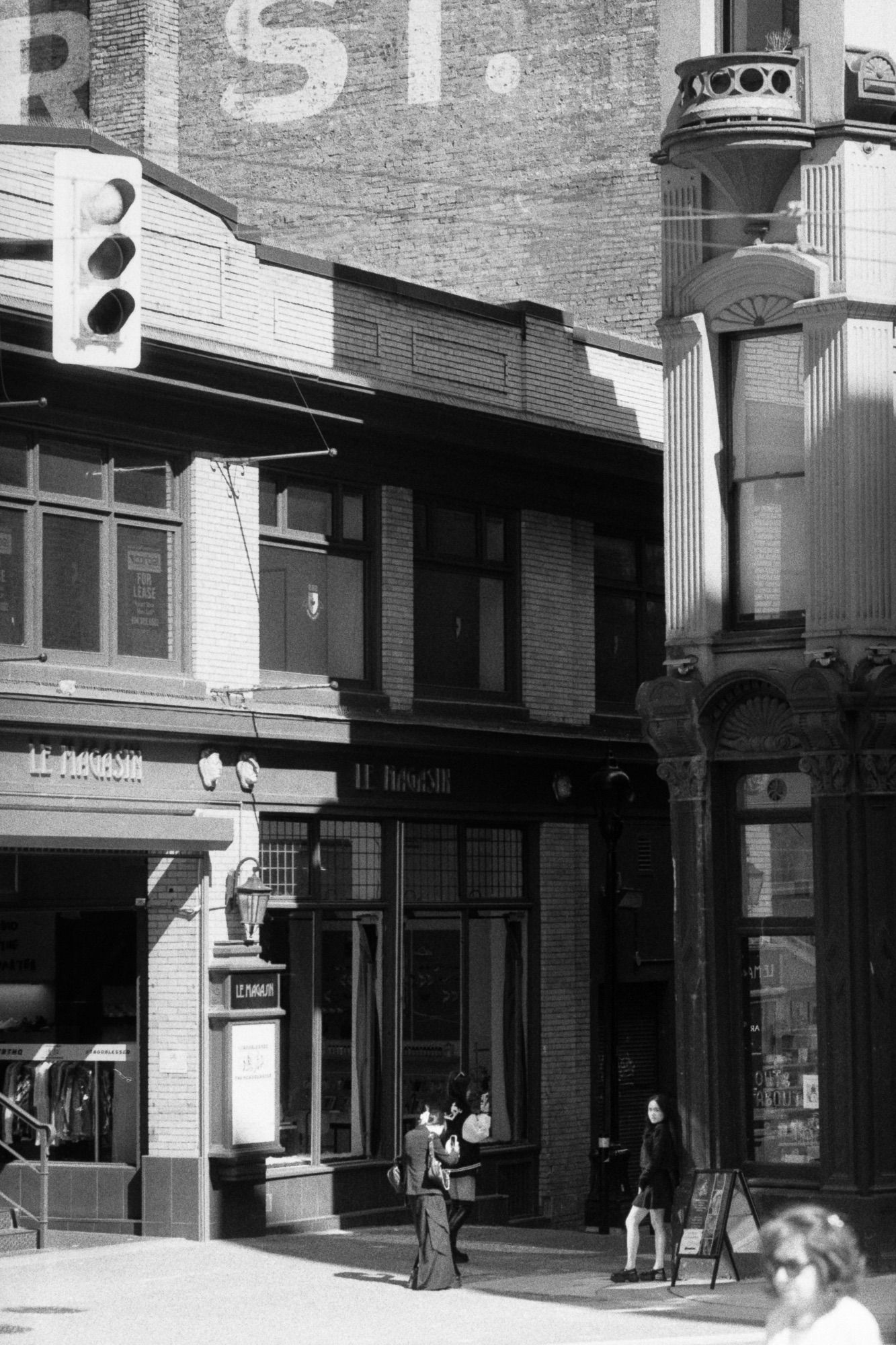 Women take photos of each other at the foot of Homer Street.