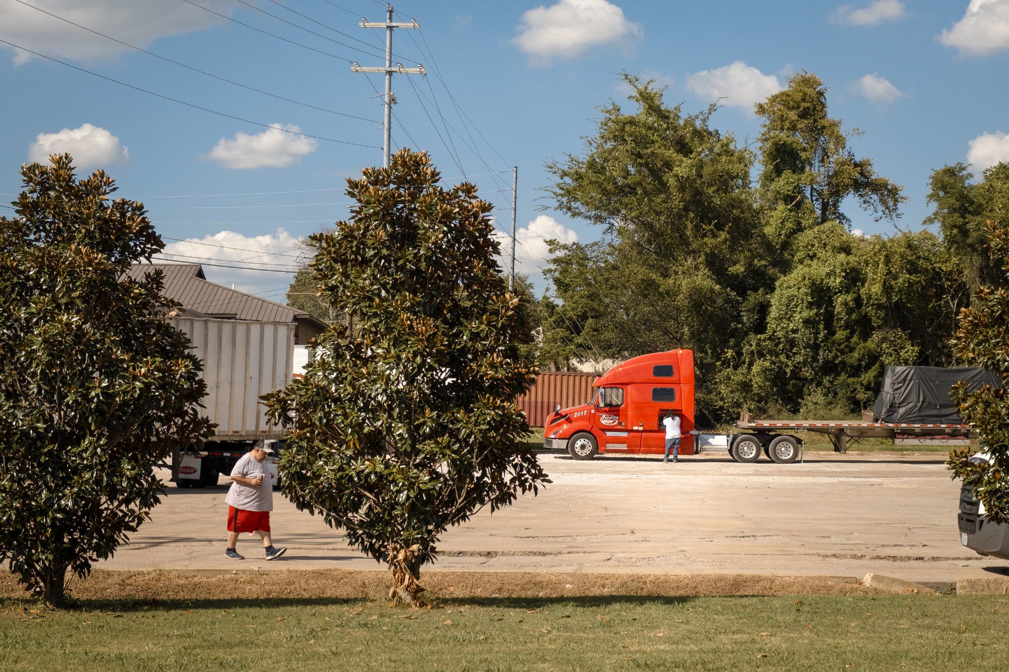 Truck drivers take a break in a lot off the highway.