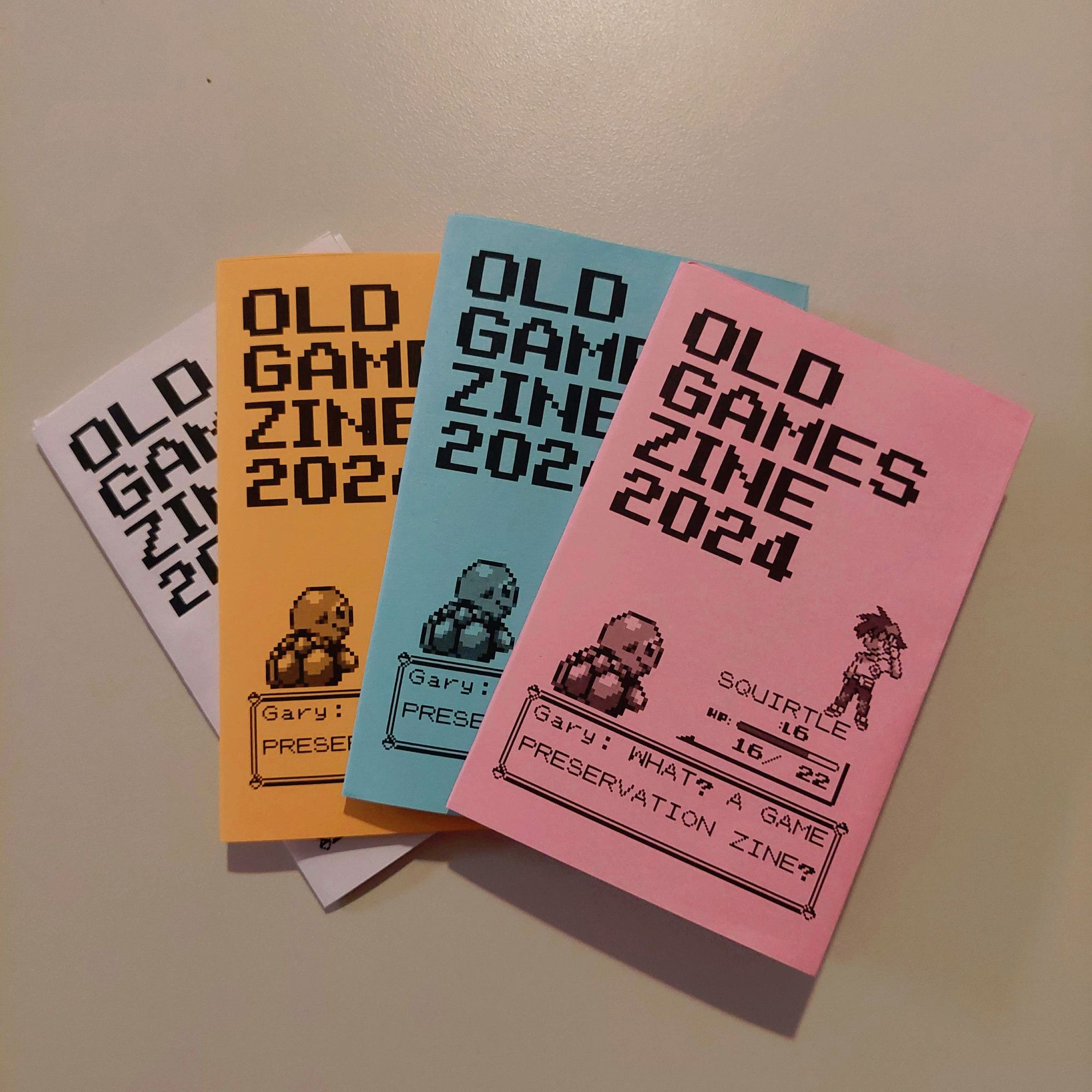 4 different colours of the "Old Game Zine 2024"