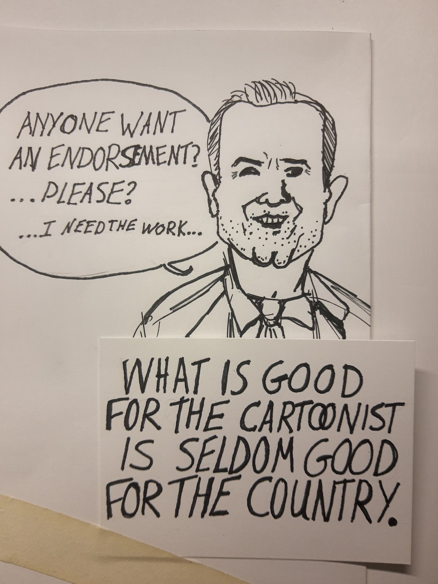 Pen and ink caricature of RFK jr, saying "anyone want an endorsement? ...Please? ...I need the work..."

Underneath a taped to the page is a note card: "What is good for the cartoonist is seldom good for the country."