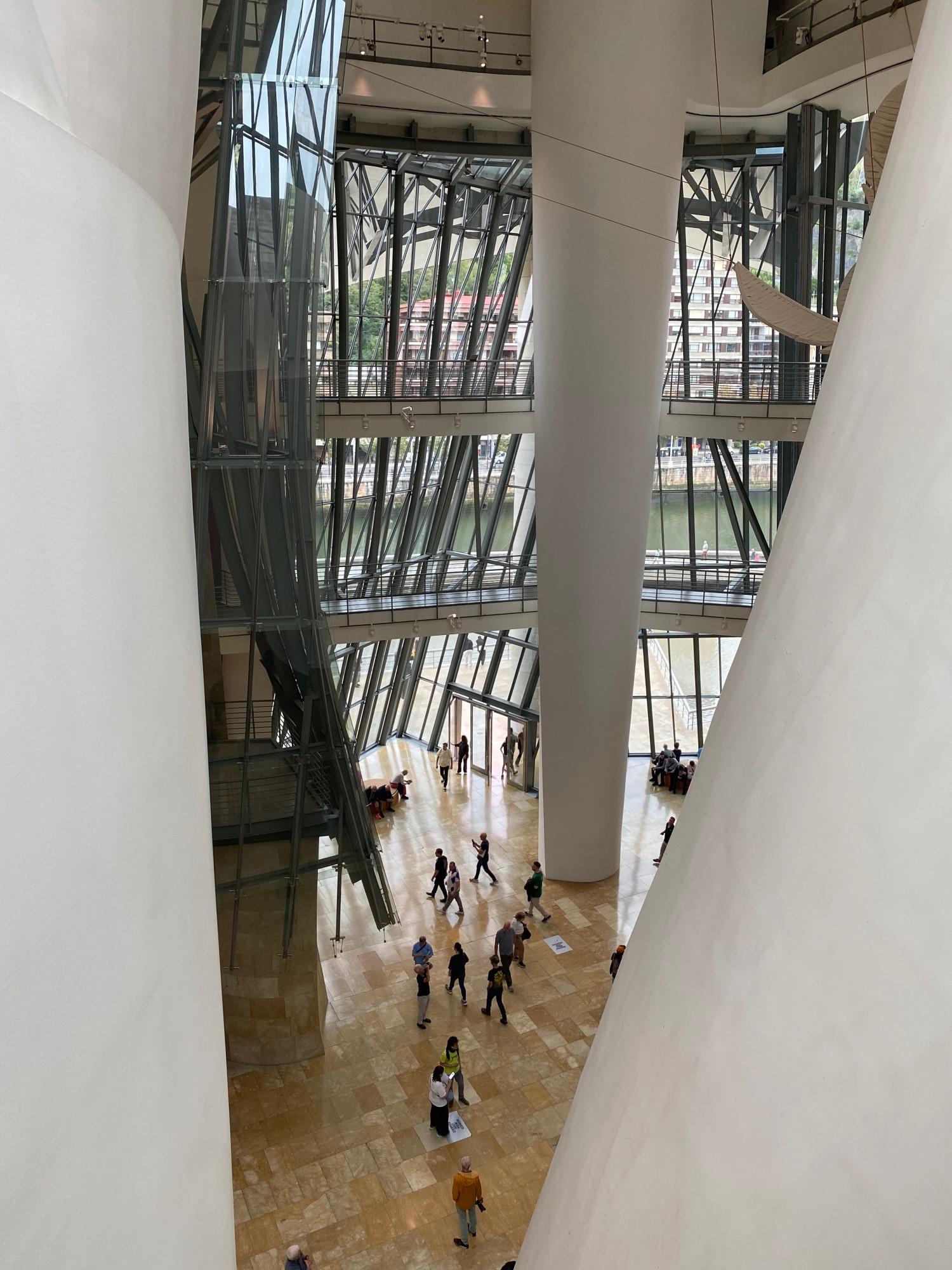 A look down at the glass, limestone, aluminum and other materials in the 3+ story atrium of the Guggenheim Bilbao