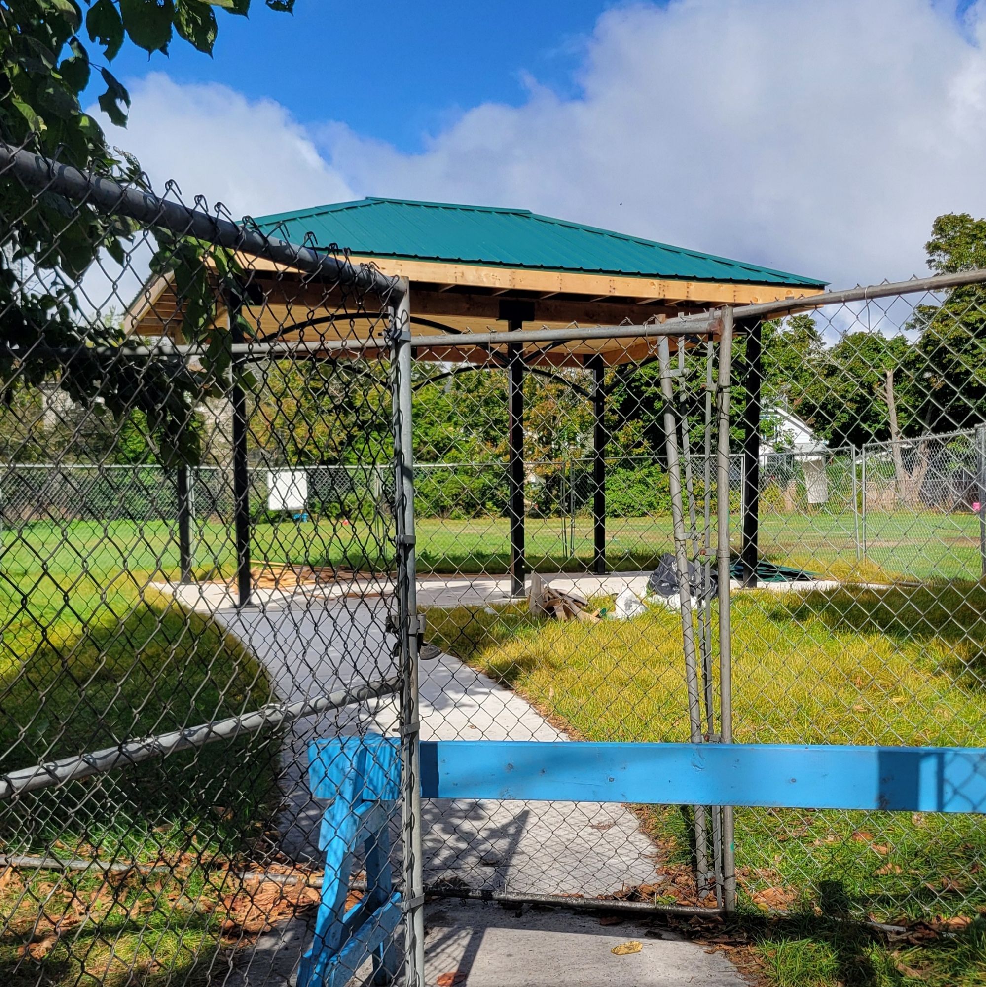 a newly installed sun shelter surrounded by green grass.