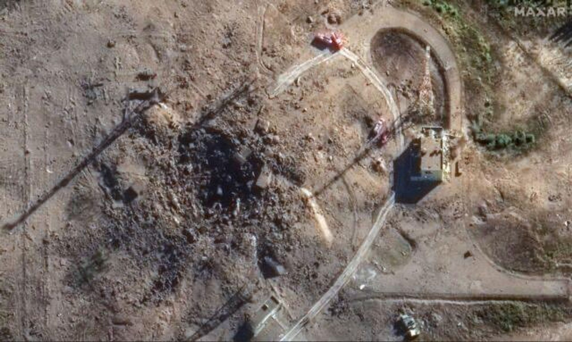 Fire trucks surround the Sarmat missile silo in this view from space on Saturday, September 21. Where the actual silo was, a blast hole and dirt are mainly what remains now. 