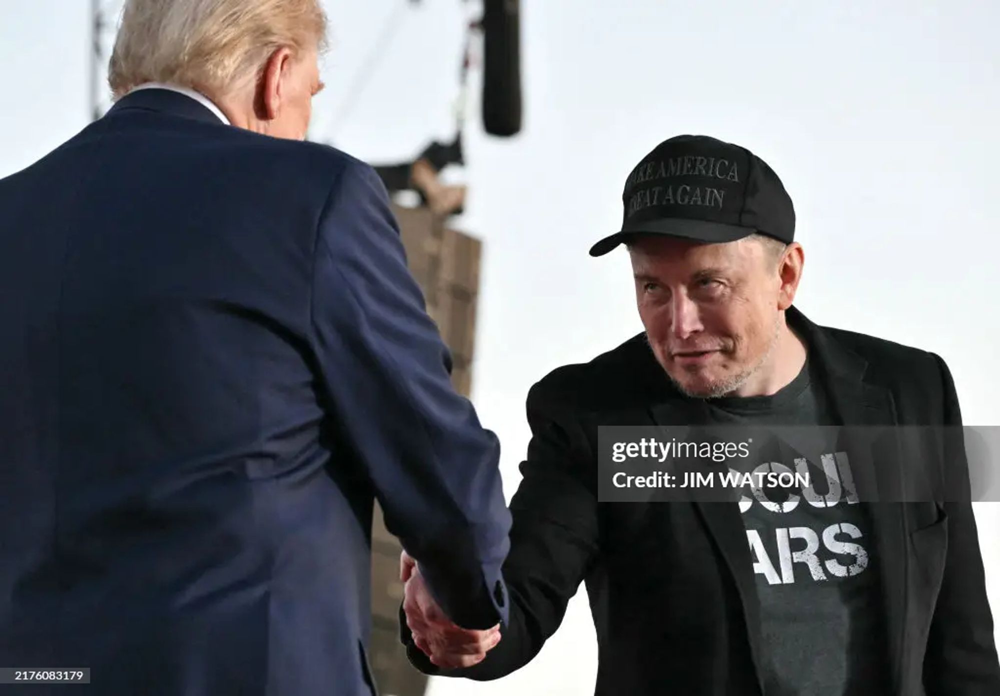 From Getty Images; Tesla CEO Elon Musk (R) joins former US President and Republican presidential candidate Donald Trump during a campaign rally at site of his first assassination attempt in Butler, Pennsylvania on October 5, 2024. (Photo by Jim WATSON / AFP) (Photo by JIM WATSON/AFP via Getty Images)