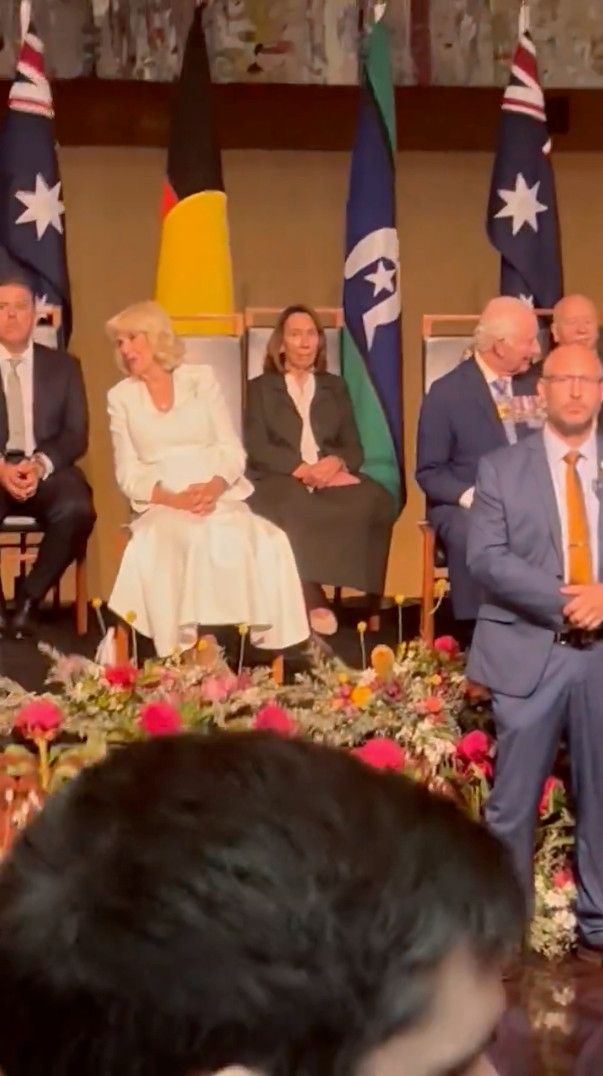 King Charles and Camilla smiling while seated in chairs at Parliament House in Australia