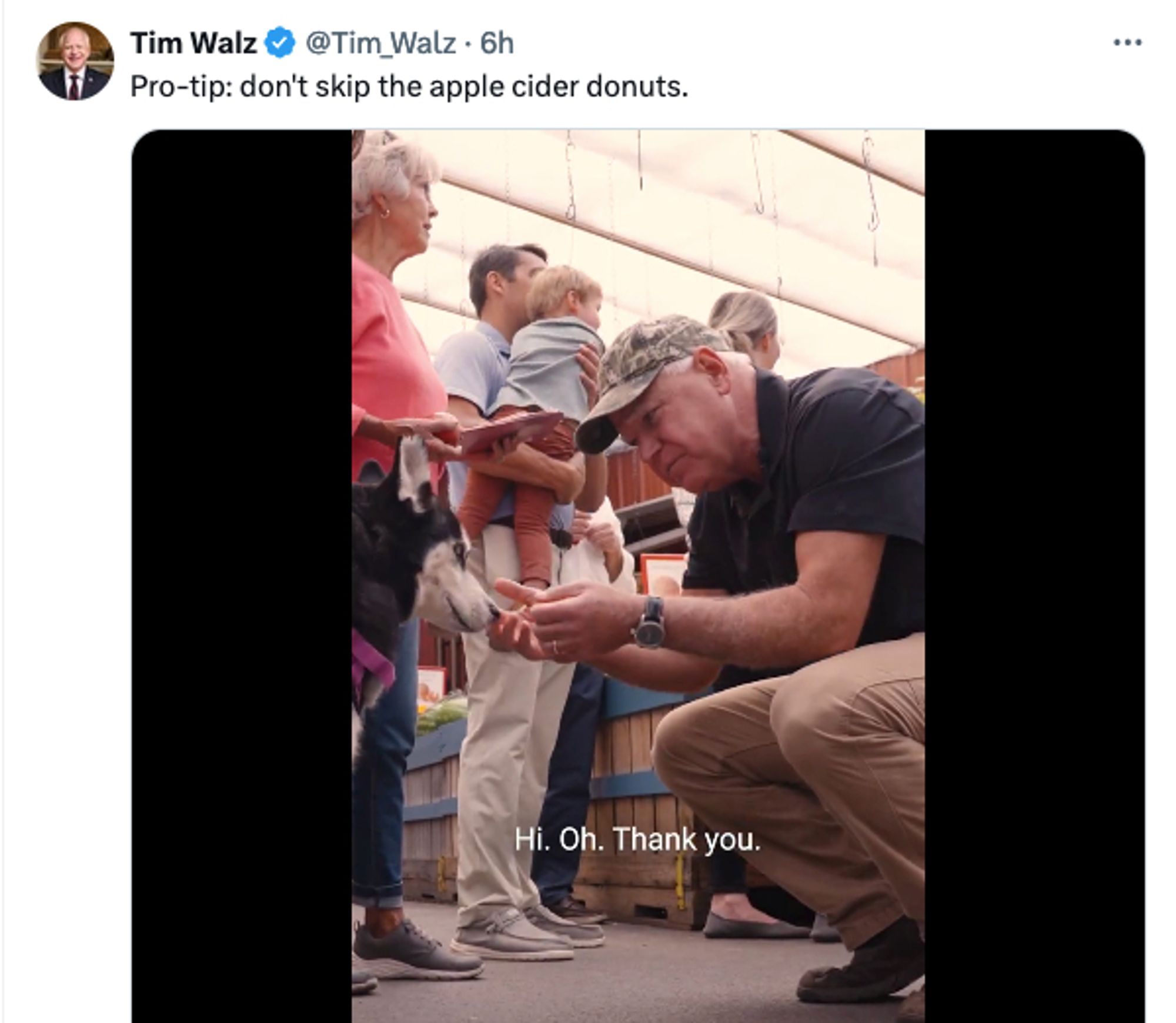 Tweet from Tim Walz where he's petting a dog and the words: pro-tip: don't skip the apple cider donuts