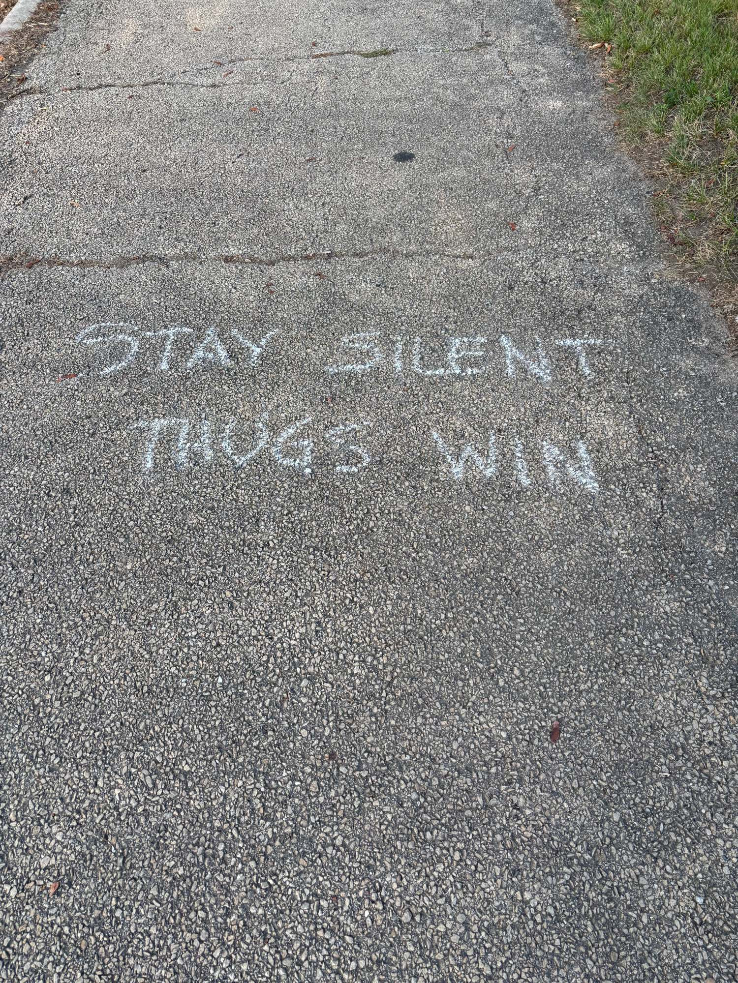 Chalked message: Stay Silent /Thugs win