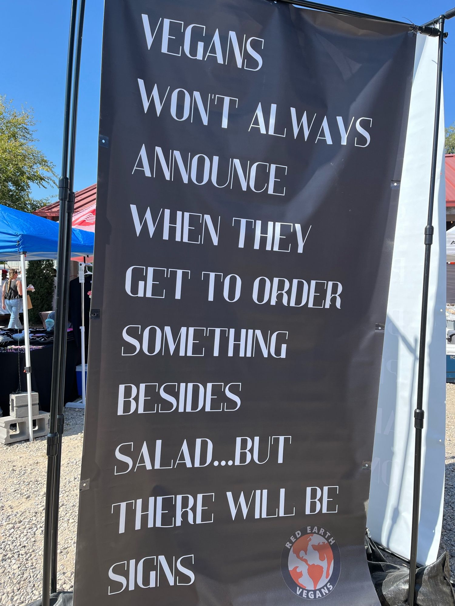 Sign that reads “Vegans won’t always announce when they get to order something besides salad… but there will be signs.”