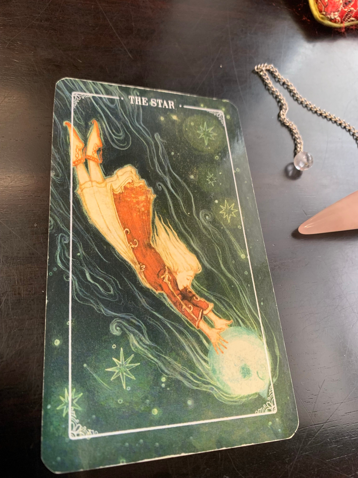 The Star tarot card. A woman flies through the sky, arms outstretched to clasp a star