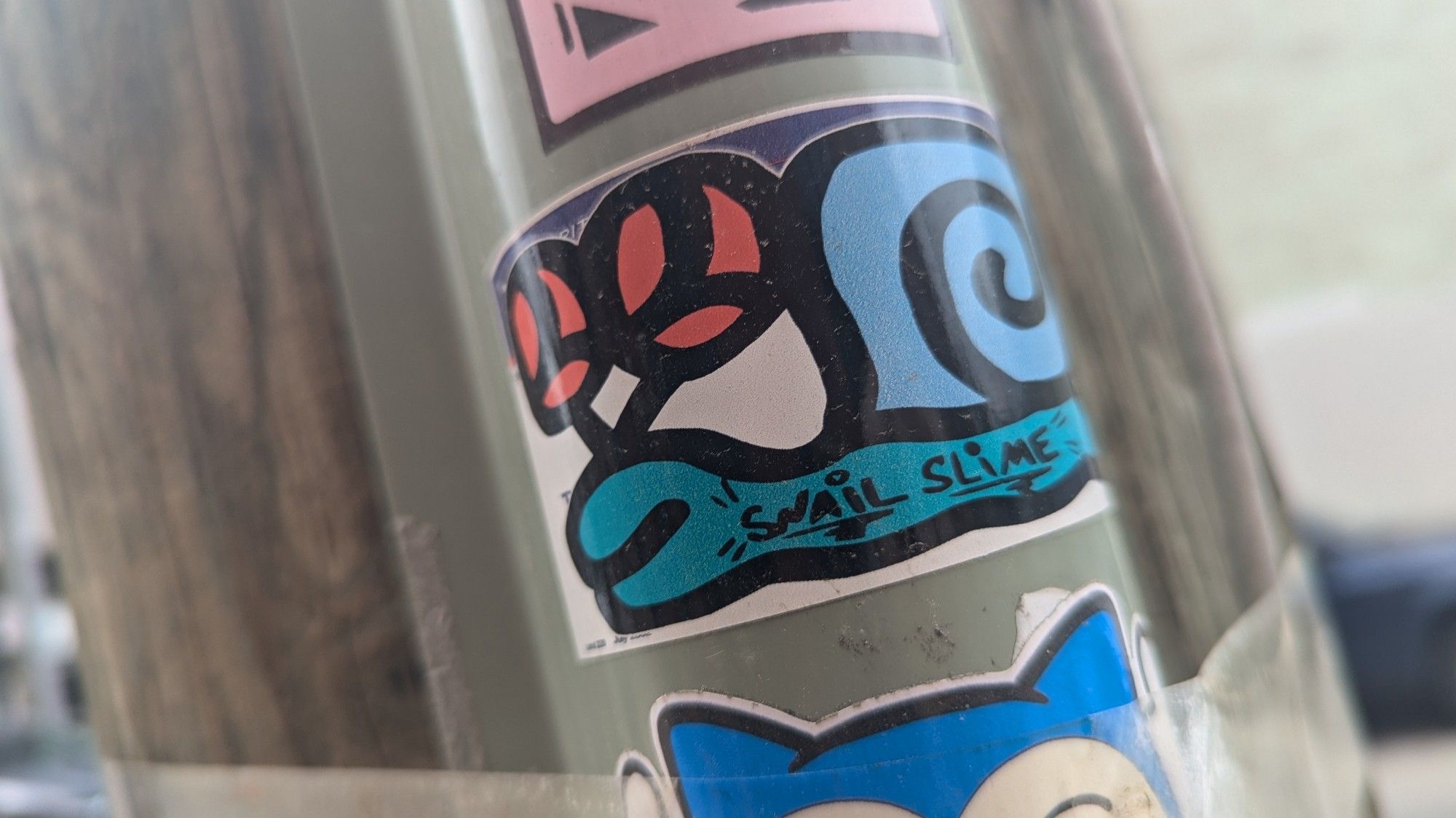 usps sticker with a red-eyes, blu -bodied 🐌 snail 

snail slime