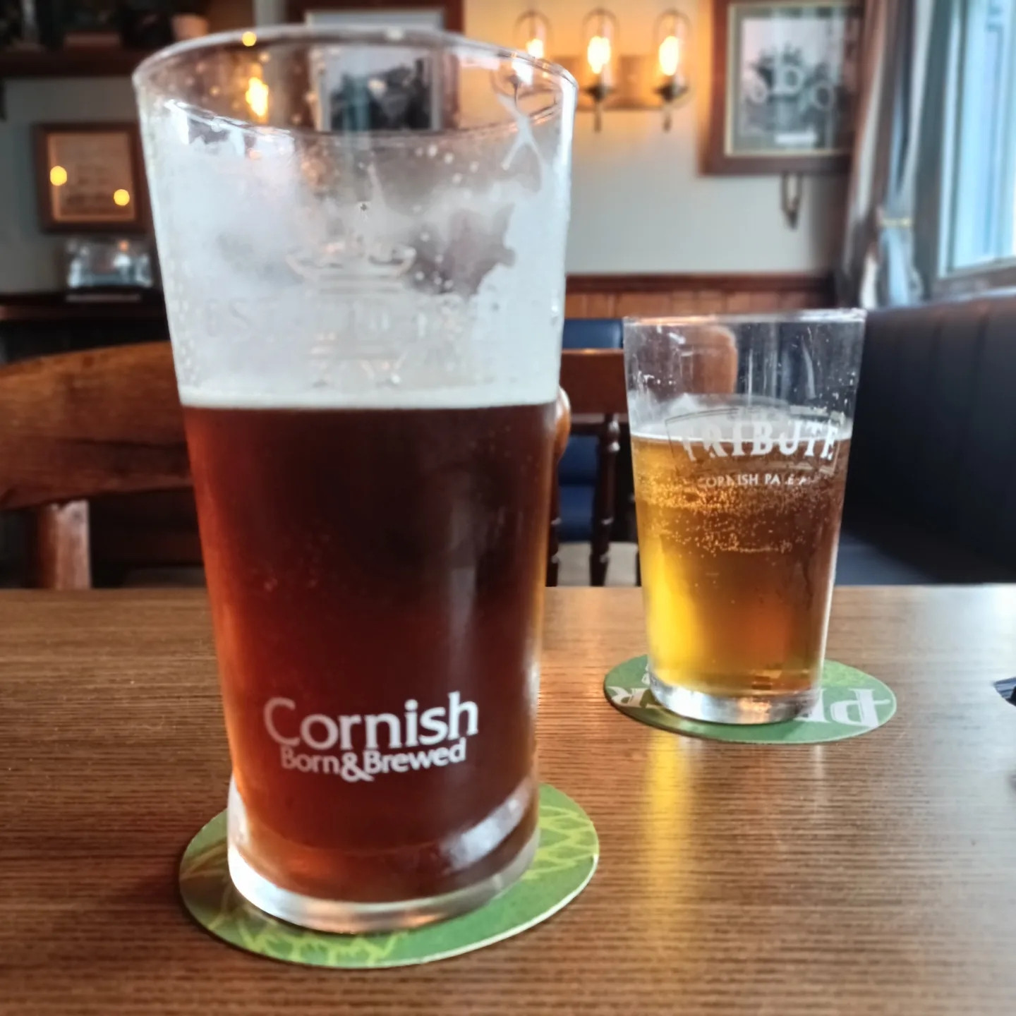 A pint of Cornish Ale and half a pint of Tribute, photographed in a pub in Coverack, Cornwall UK, a few weeks ago.