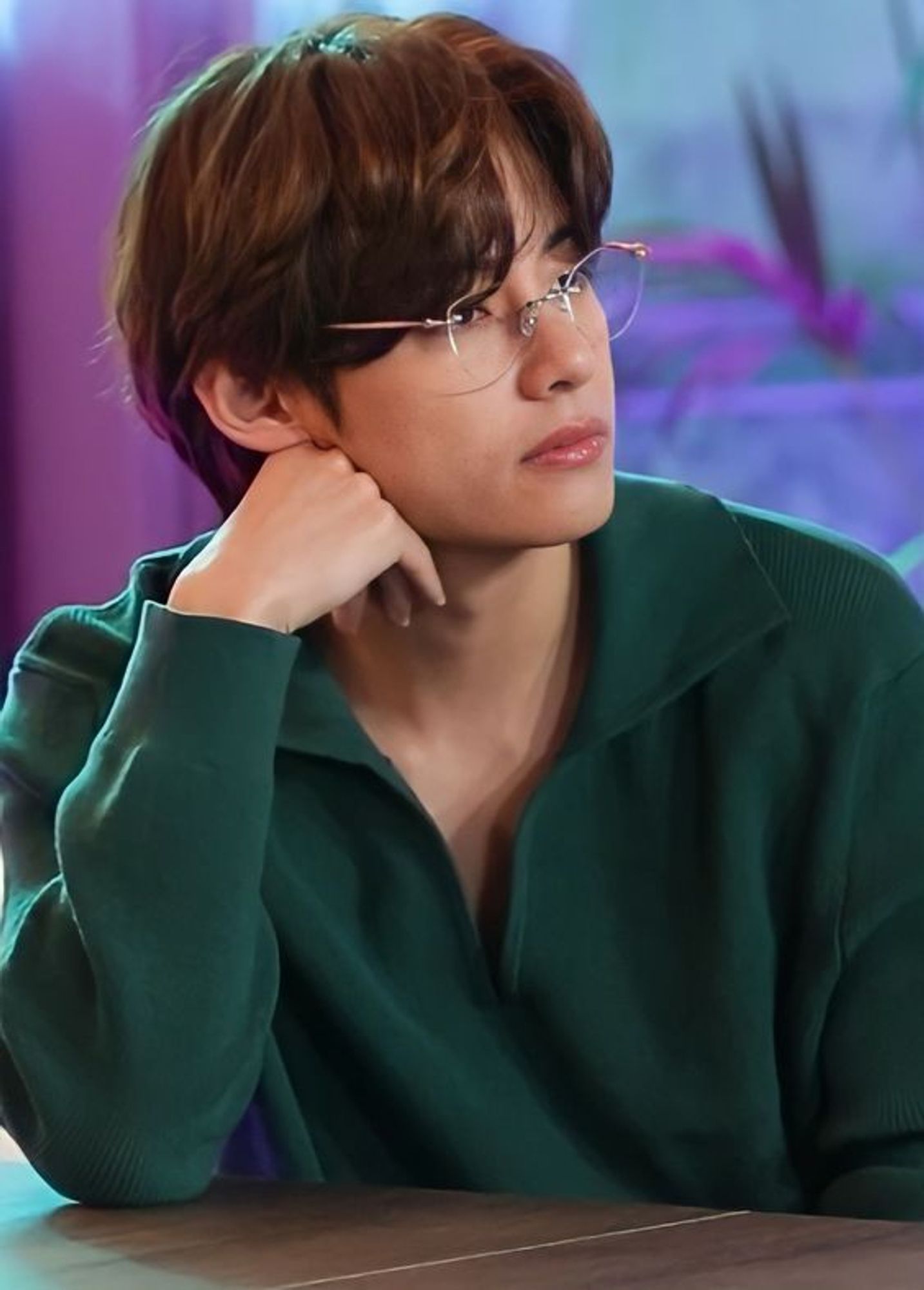 Tae in "Tae Green", brown soft hair, wire rims, leaning on his hand (have you noticed he does this a lot? well I sure have).