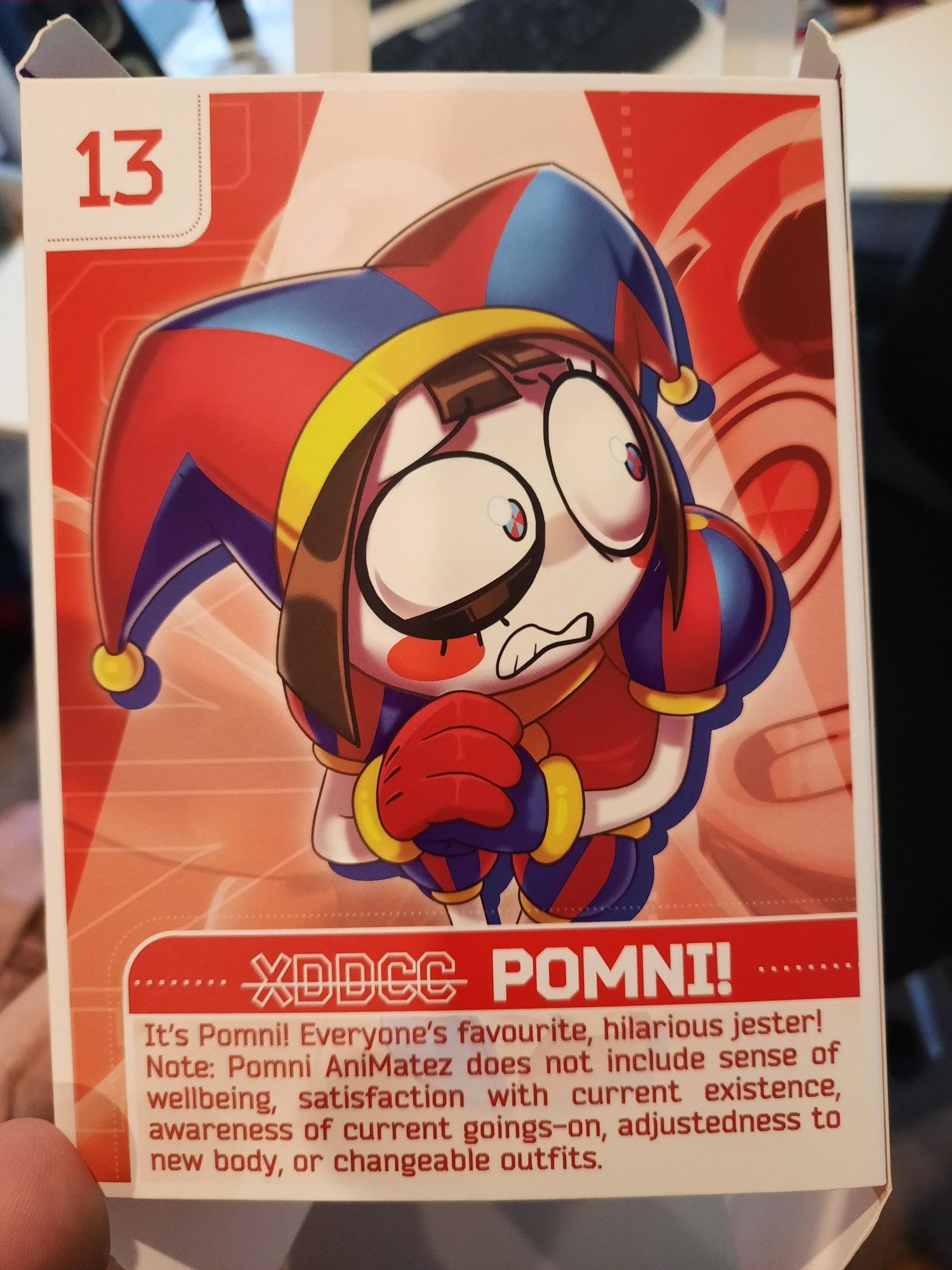 The back of the box for the Pomni Animatez figurine. It reads:

"It's Pomni! Everyone's favourite, hilarious jester!
Note: Pomni Animatez does not include sense of wellbeing, satisfaction with current existence, awareness of current goings-on, adjustedness to new body, or changeable outfits."