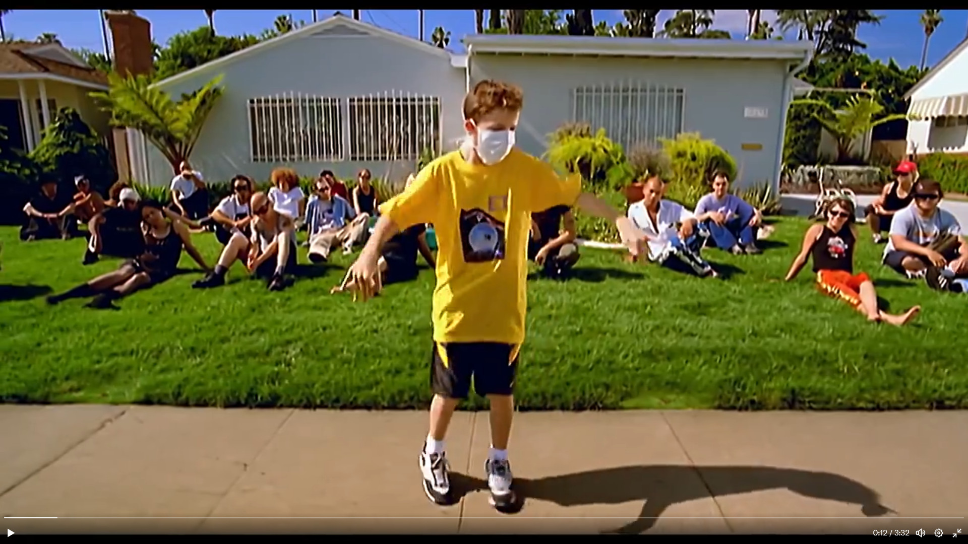 Bobby Edner in the video for Alien Ant Farm's Smooth Criminal. He is wearing a yellow shirt, white facemask and black shorts