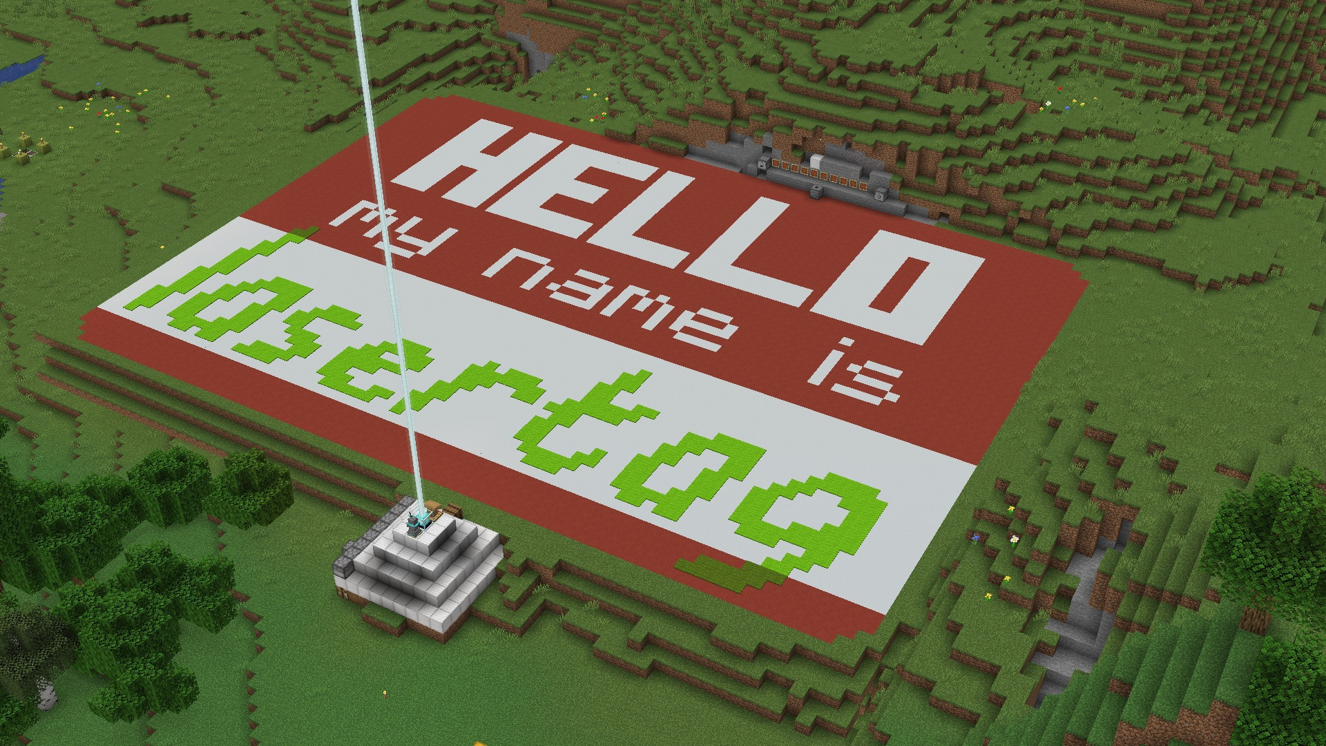 A screenshot of Microsoft’s game Minecraft showing a concrete name tag approximately 80meters wide that reads “Hello my name is Lasertag.”