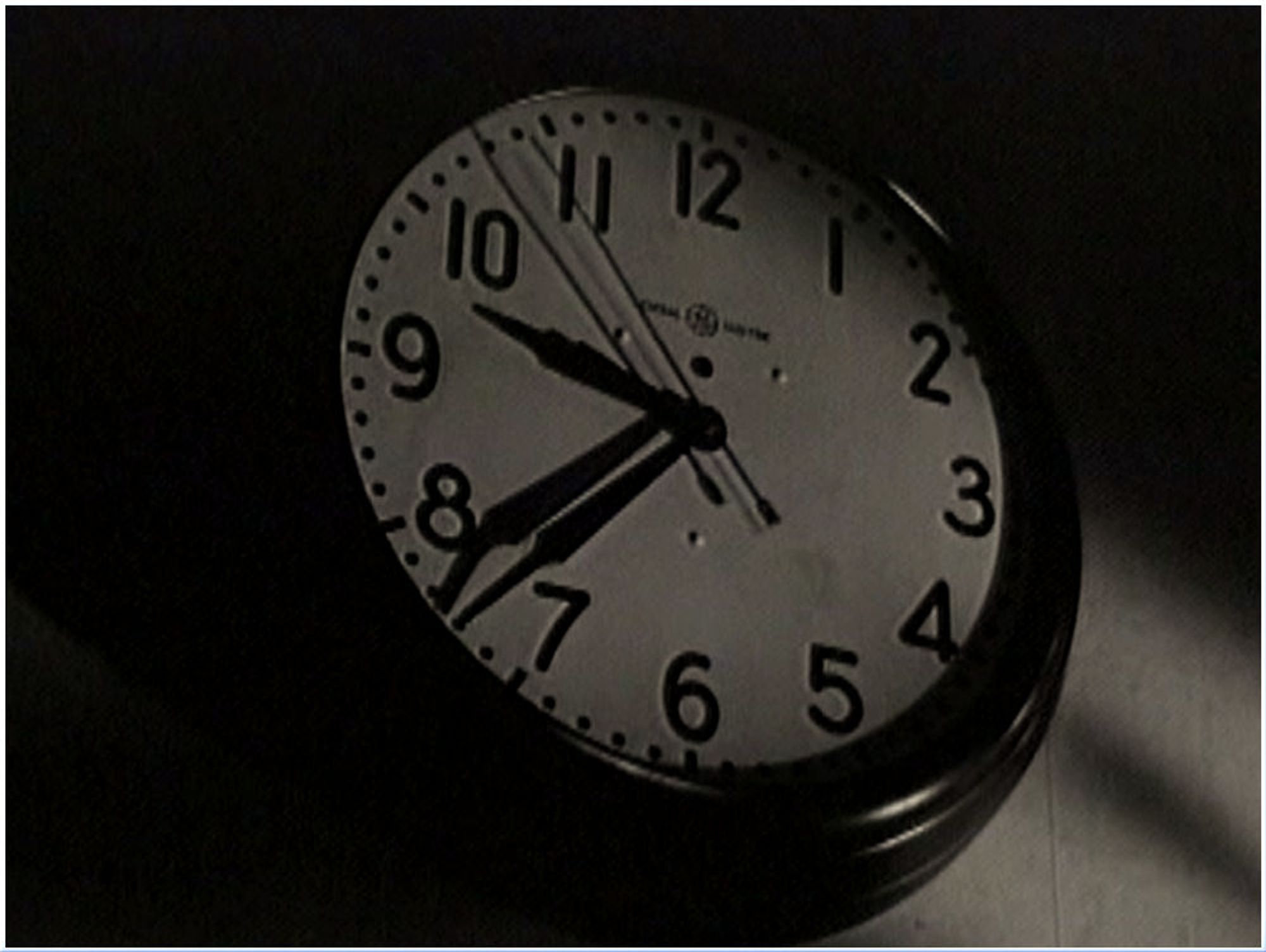 screenshot from the film "The Snake Pit" showing an analog wall clock displaying the time 9:37