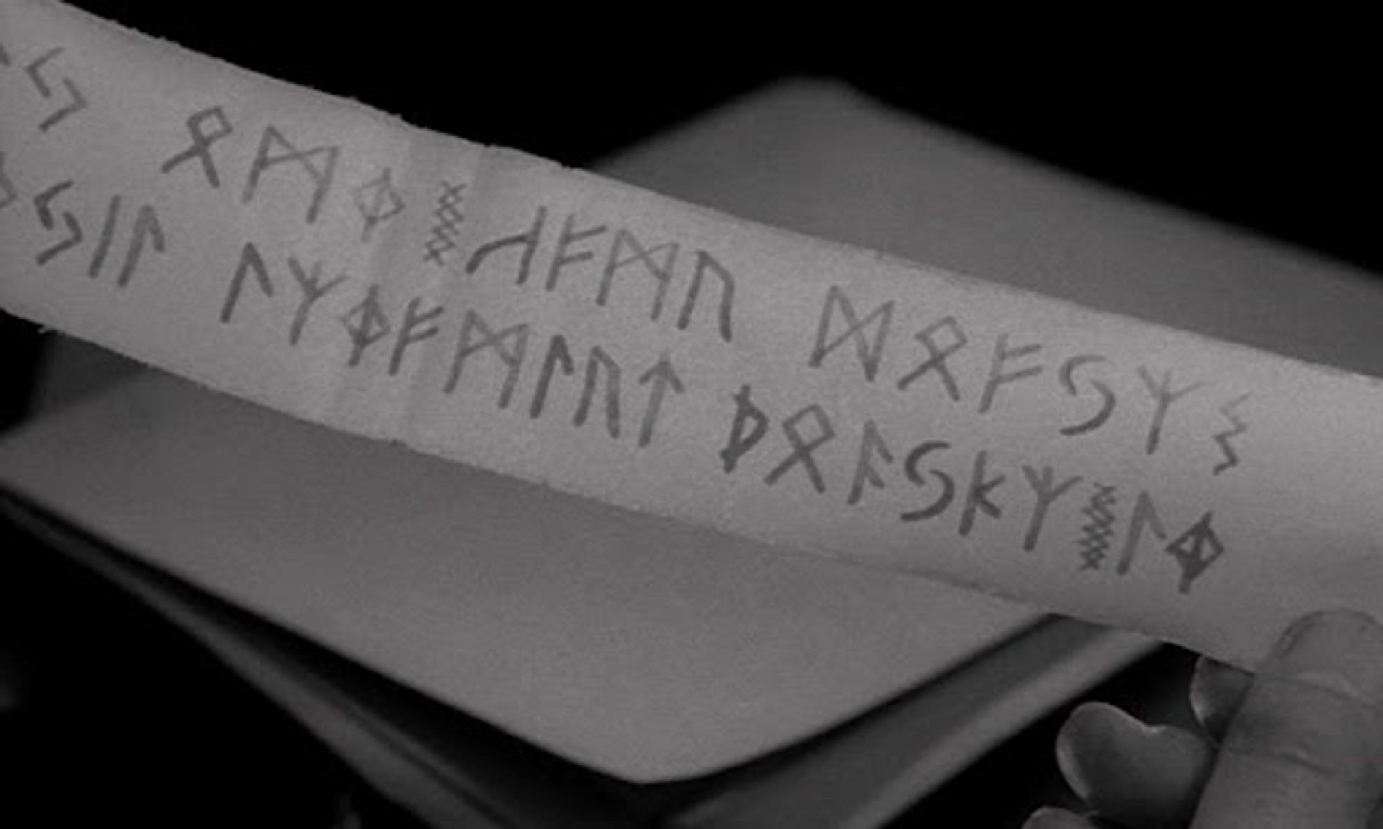 black and white film still of deadly runes on parchment