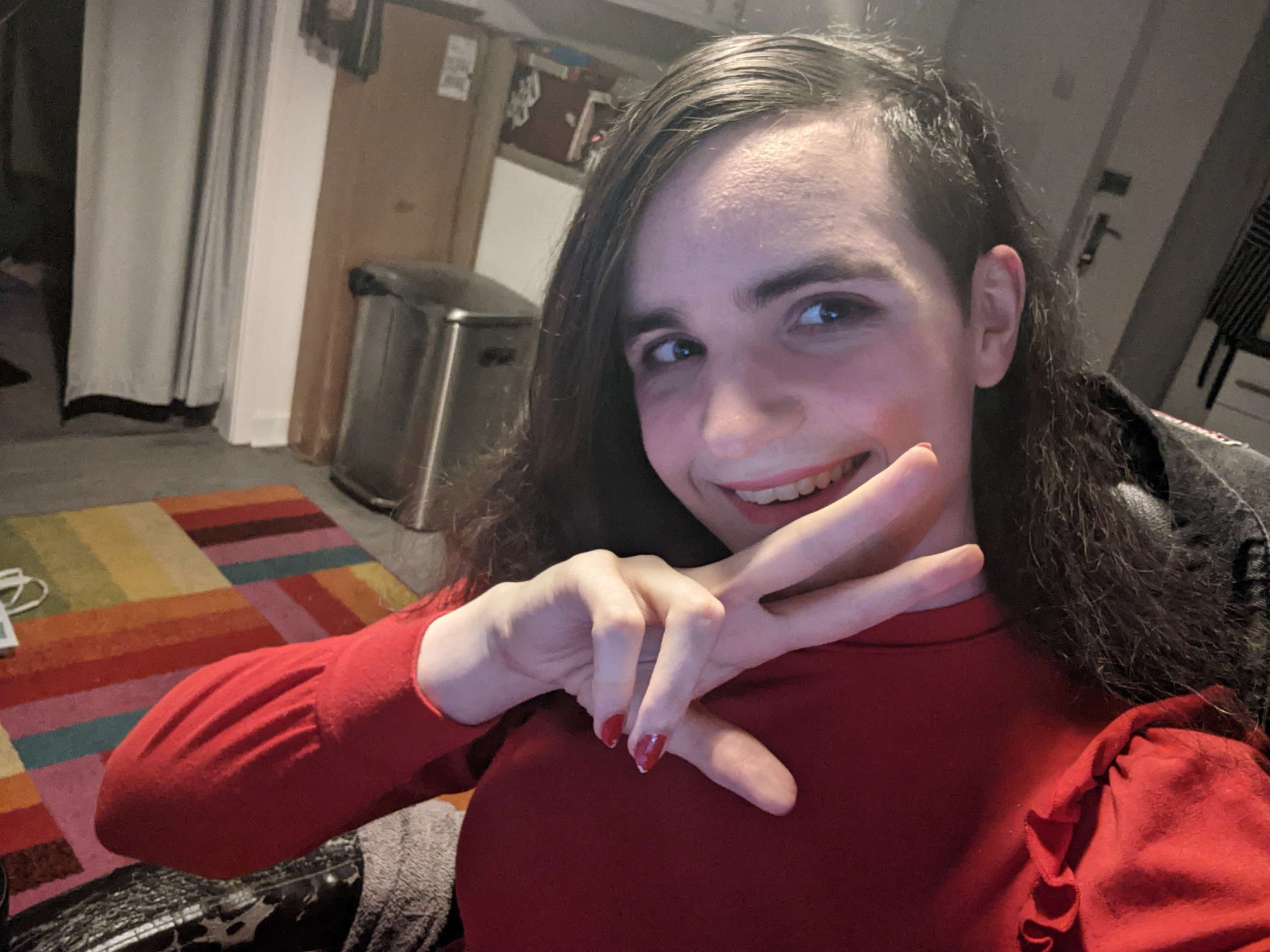 Me doing the V-pose at the camera, with a matching red dress, nails and lipstick. My smile is so warm you would die instantaneously :)