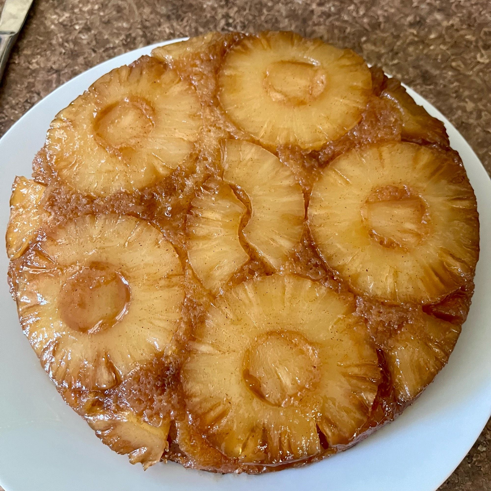 A pretty pineapple upside down cake on a plate