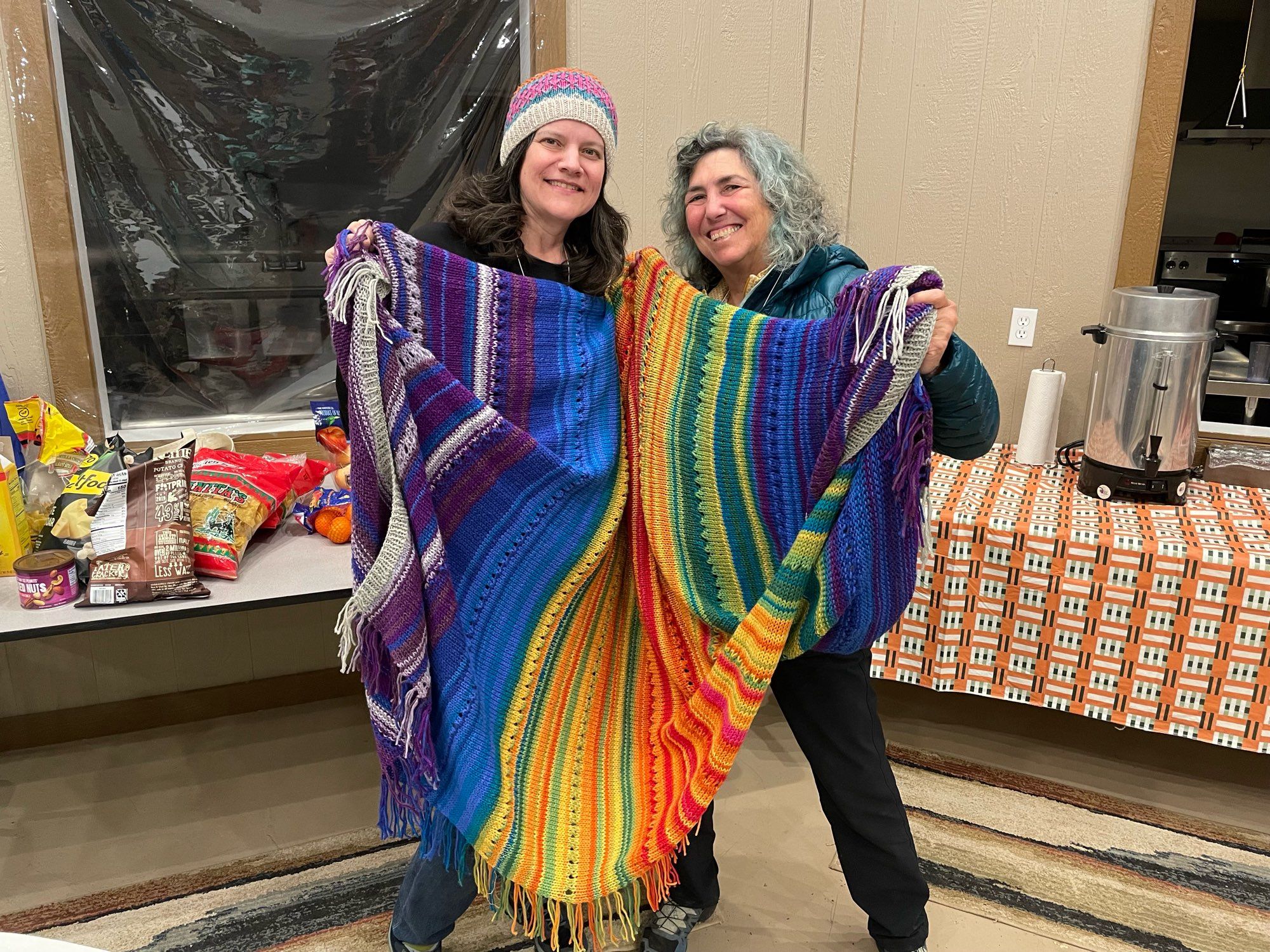 Sarah an I holding the blanket she knitted and I won