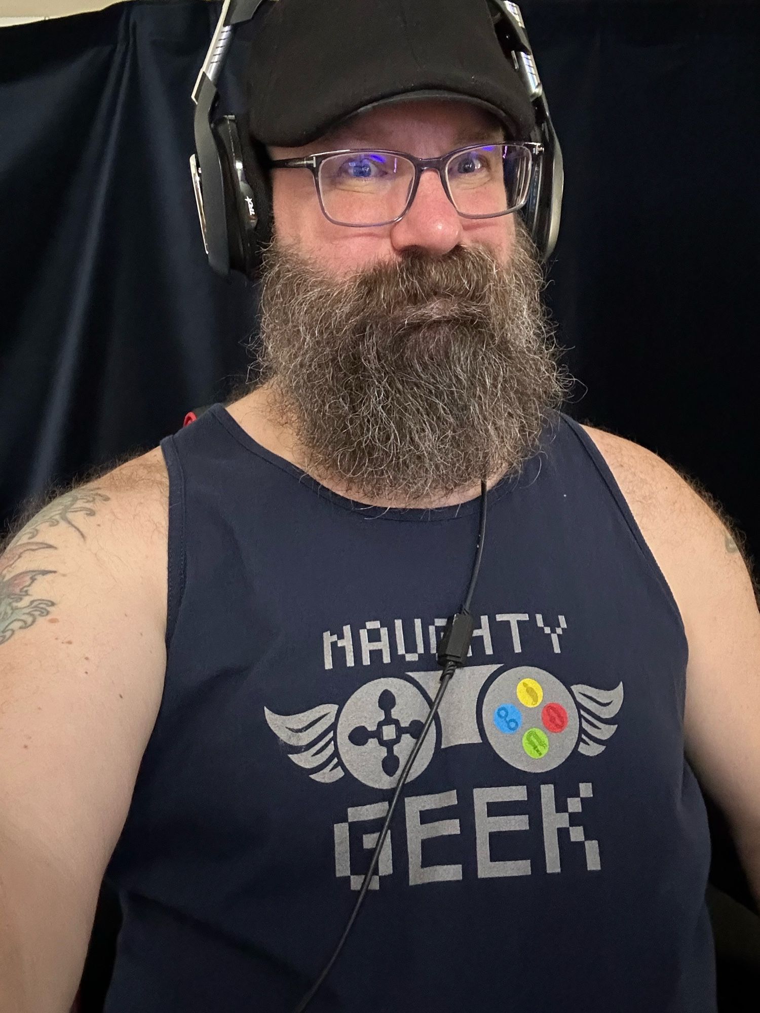 Bear is adorned with a Naughty Geek tank top he won from Watts The Safe Word